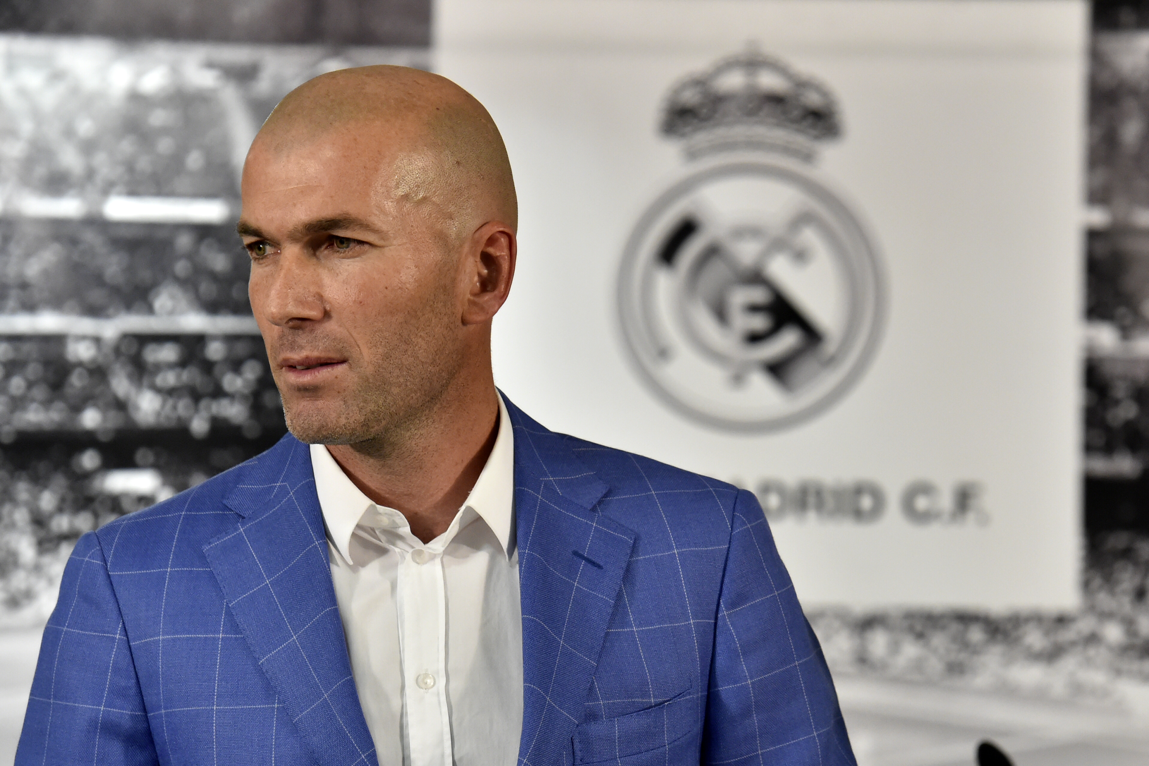 Real Madrid's new French coach Zinedine Zidane poses after a statement of Real Madrid's president at the Santiago Bernabeu stadium in Madrid on January 4, 2016. Rafael Benitez's unhappy reign in charge of Real Madrid came to an end after just seven months and 25 games when he was sacked and replaced by club legend Zinedine Zidane today.   AFP PHOTO/ GERARD JULIEN / AFP / GERARD JULIEN        (Photo credit should read GERARD JULIEN/AFP/Getty Images)