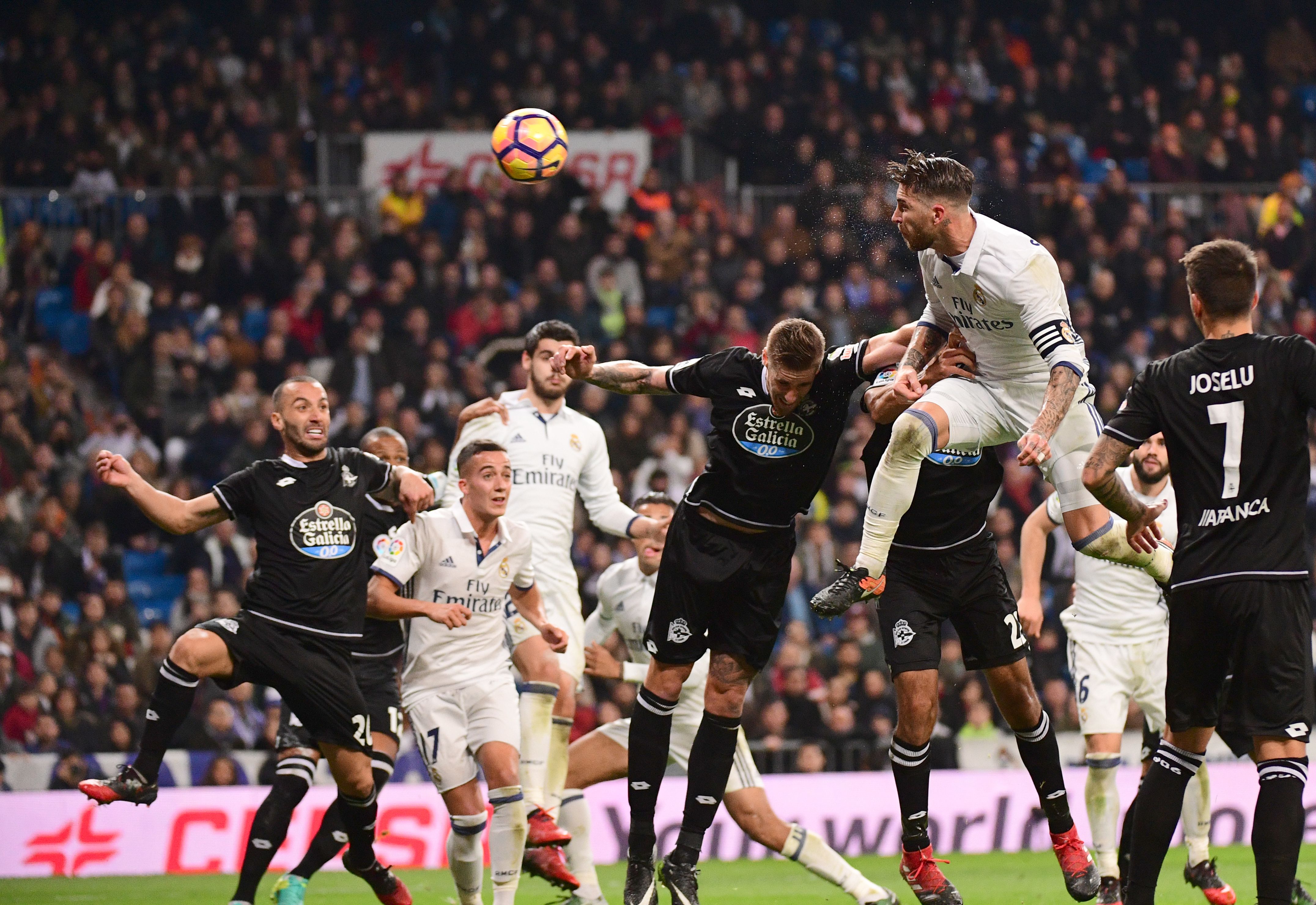 Real Madrid's defender Sergio Ramos (R) heads the ball to score during the Spanish league football match Real Madrid CF vs RC Deportivo at the Santiago Bernabeu stadium in Madrid on December 10, 2016. / AFP / PIERRE-PHILIPPE MARCOU        (Photo credit should read PIERRE-PHILIPPE MARCOU/AFP/Getty Images)