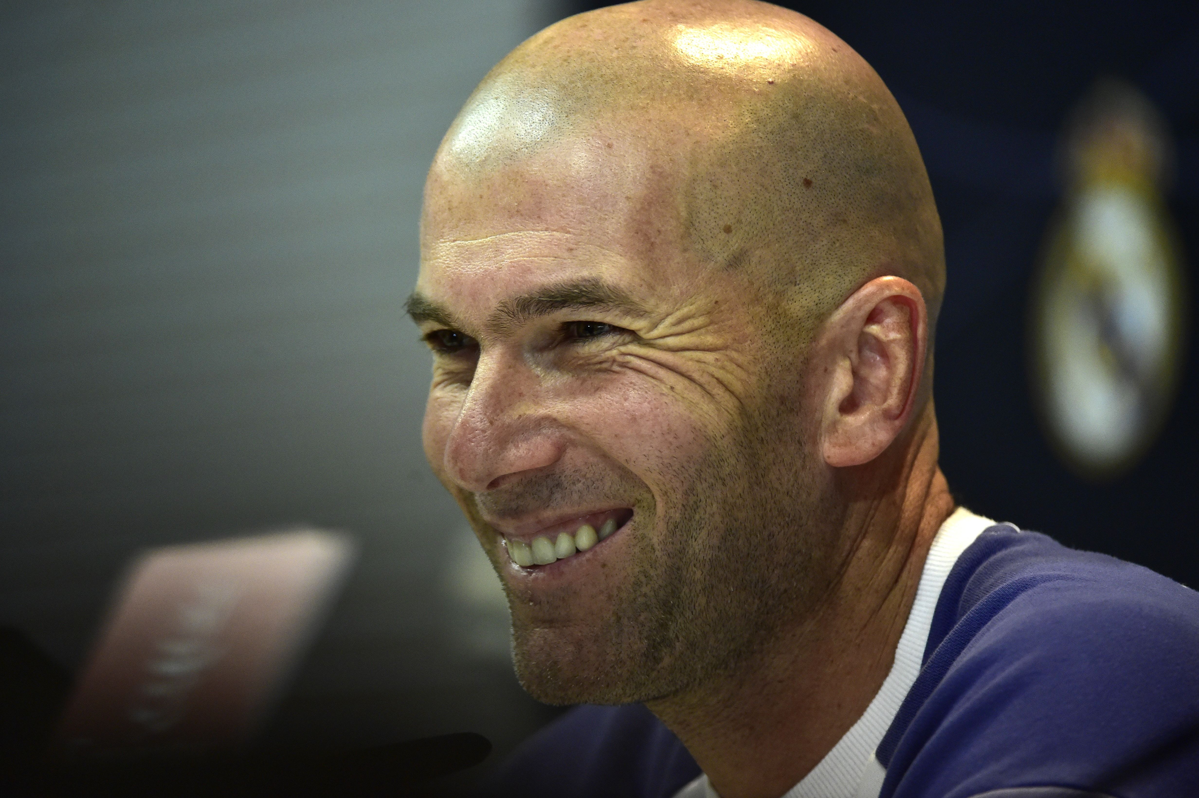 Real Madrid's French coach Zinedine Zidane smiles during a press conference at Valdebebas Sport City in Madrid on December 9, 2016 on the eve of the Spanish League match Real Madrid CF vs RC Deportivo de La Coruna. / AFP / GERARD JULIEN        (Photo credit should read GERARD JULIEN/AFP/Getty Images)