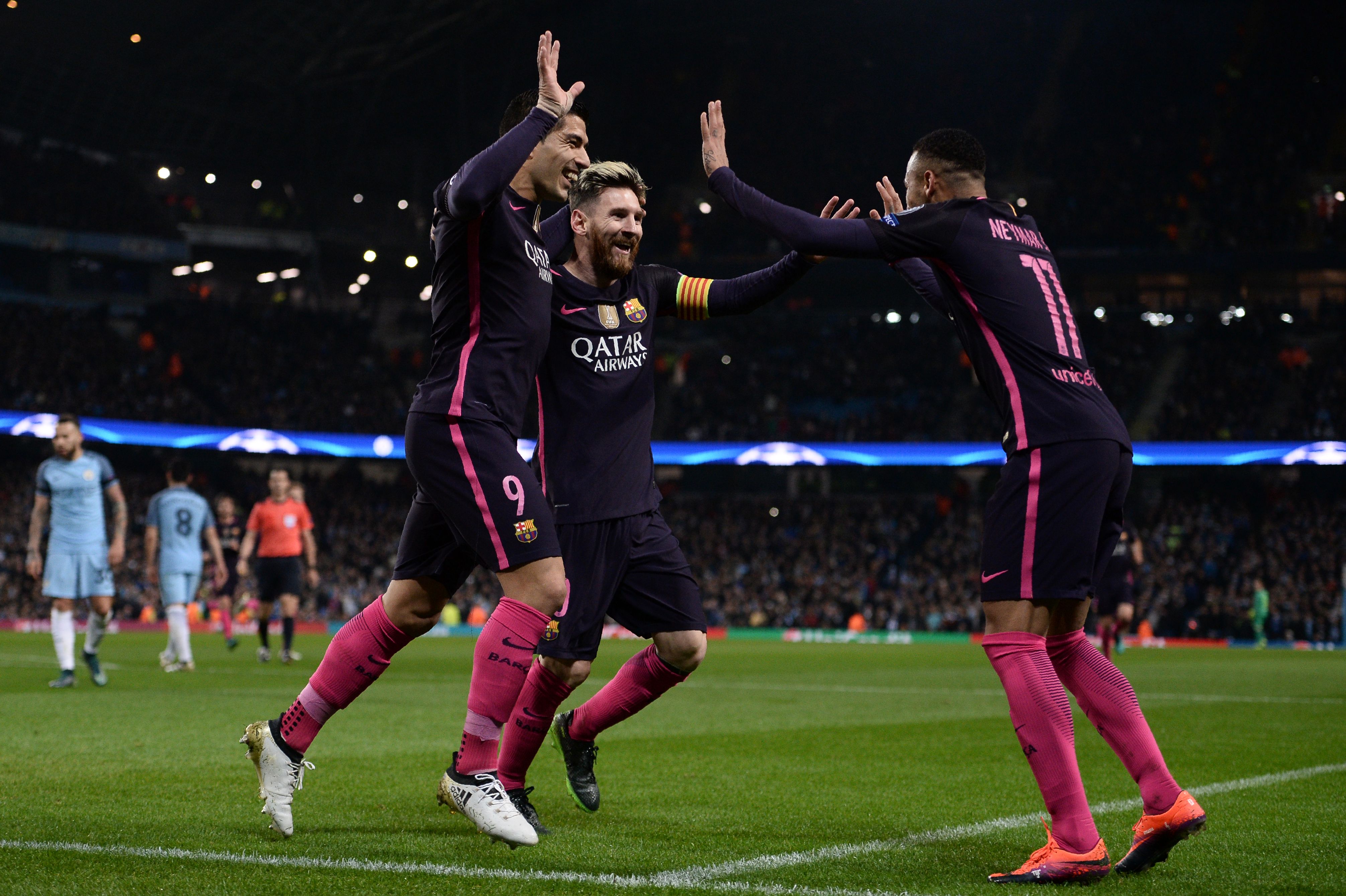 Barcelona's Argentinian striker Lionel Messi (C) celebrates scoring his team's first goal with Barcelona's Uruguayan striker Luis Suarez (L) and Barcelona's Brazilian striker Neymar during the UEFA Champions League group C football match between Manchester City and Barcelona at the Etihad Stadium in Manchester, north west England on November 1, 2016. / AFP / OLI SCARFF        (Photo credit should read OLI SCARFF/AFP/Getty Images)