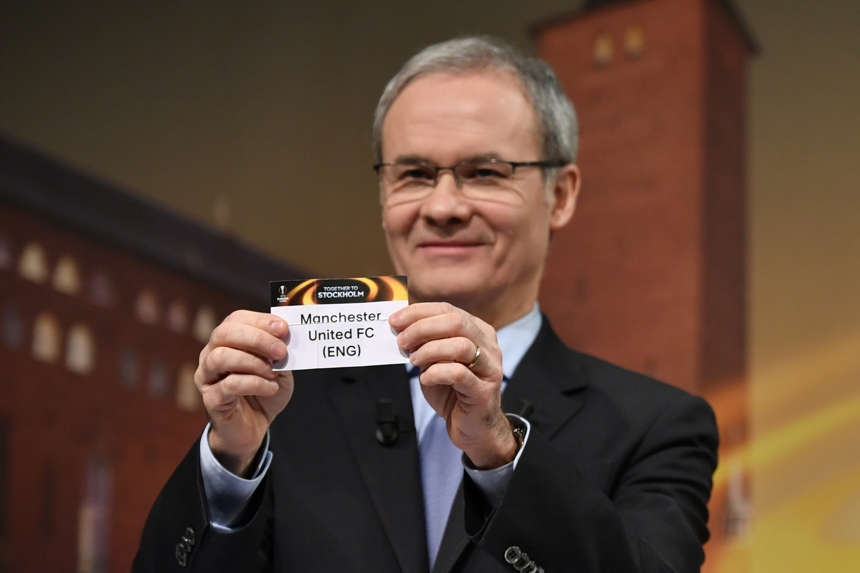 UEFA deputy secretary general Giorgio Marchetti holds the name of Manchester United during the draw for the round of 32 of the UEFA Europa League football tournament at the UEFA headquarters in Nyon on December 12, 2016. / AFP / Fabrice COFFRINI        (Photo credit should read FABRICE COFFRINI/AFP/Getty Images)