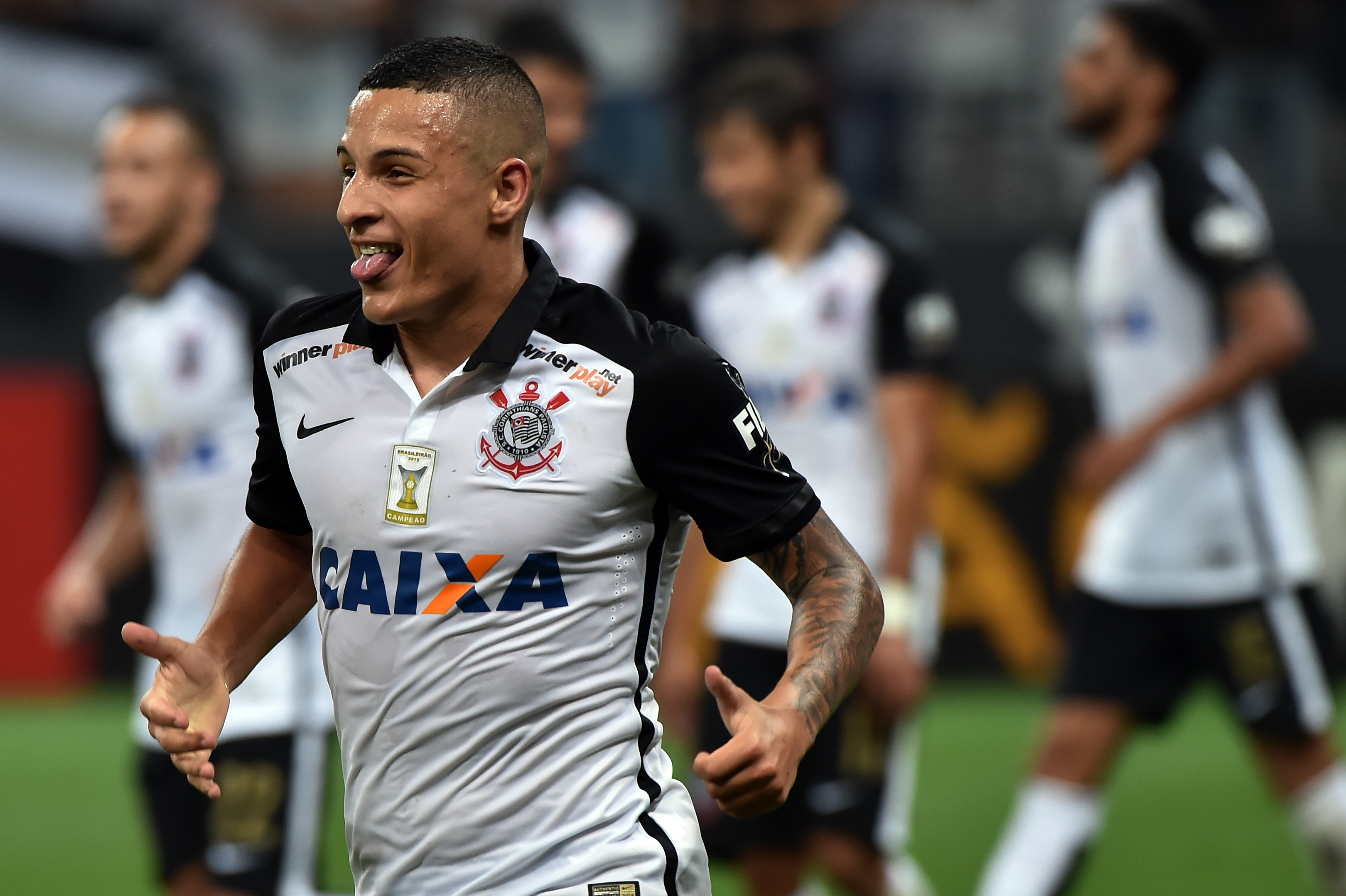 Guilherme Arana (L) of Brazils Corinthians, celebrates his goal scored against Chile's Cobresal, during their 2016 Copa Libertadores football match held at Arena Corinthians stadium, in Sao Paulo, Brazil, on April 20, 2016. / AFP / NELSON ALMEIDA        (Photo credit should read NELSON ALMEIDA/AFP/Getty Images)