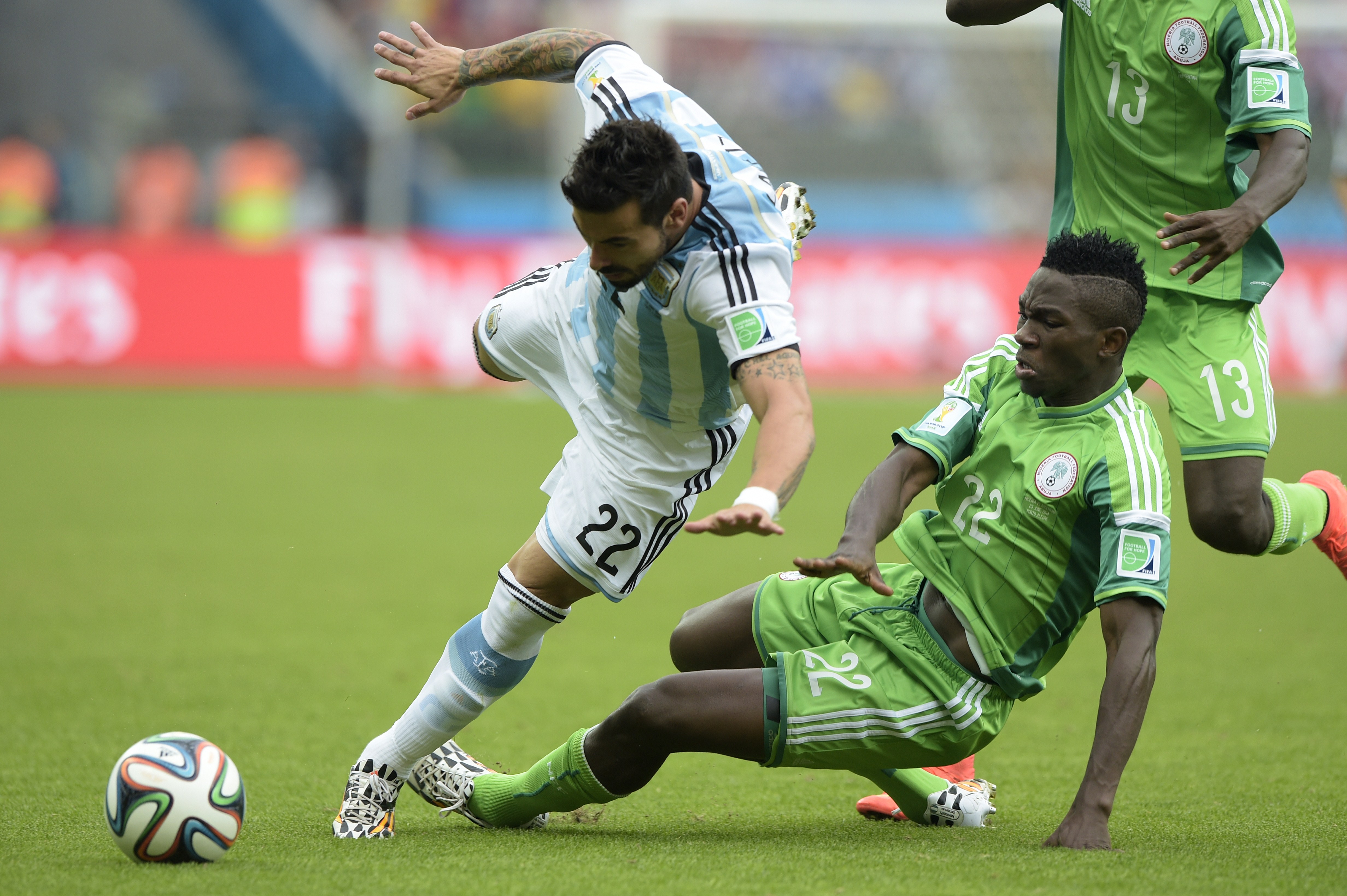 Argentina's forward Ezequiel Lavezzi (L) and Nigeria's defender Kenneth Omeruo, vie for the ball during a Group F football match between Nigeria and Argentina at the Beira-Rio Stadium in Porto Alegre during the 2014 FIFA World Cup on June 25, 2014.  AFP PHOTO / JUAN MABROMATA        (Photo credit should read JUAN MABROMATA/AFP/Getty Images)