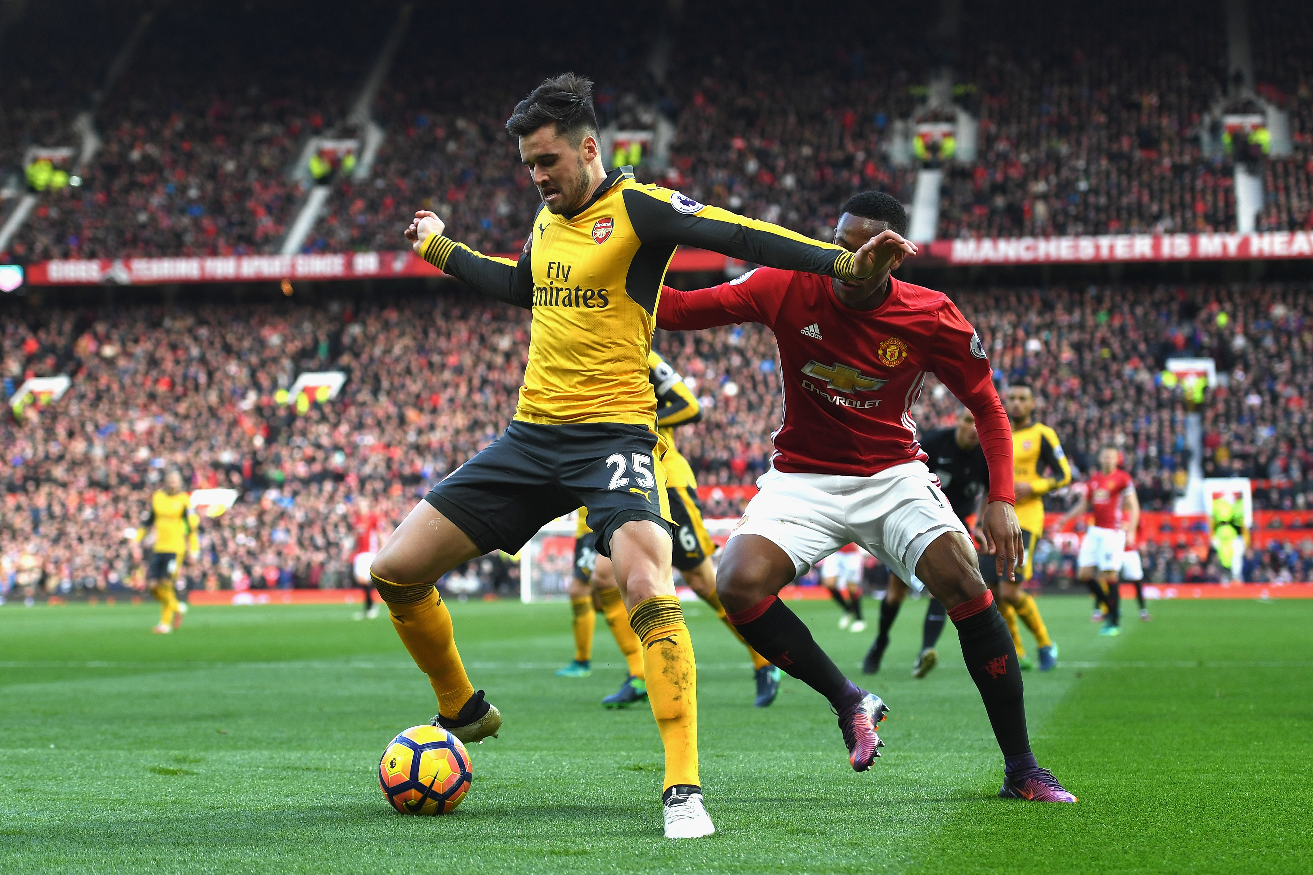 MANCHESTER, ENGLAND - NOVEMBER 19: Carl Jenkinson of Arsenal (L) is put under pressure from Anthony Martial of Manchester United (R) during the Premier League match between Manchester United and Arsenal at Old Trafford on November 19, 2016 in Manchester, England.  (Photo by Shaun Botterill/Getty Images)