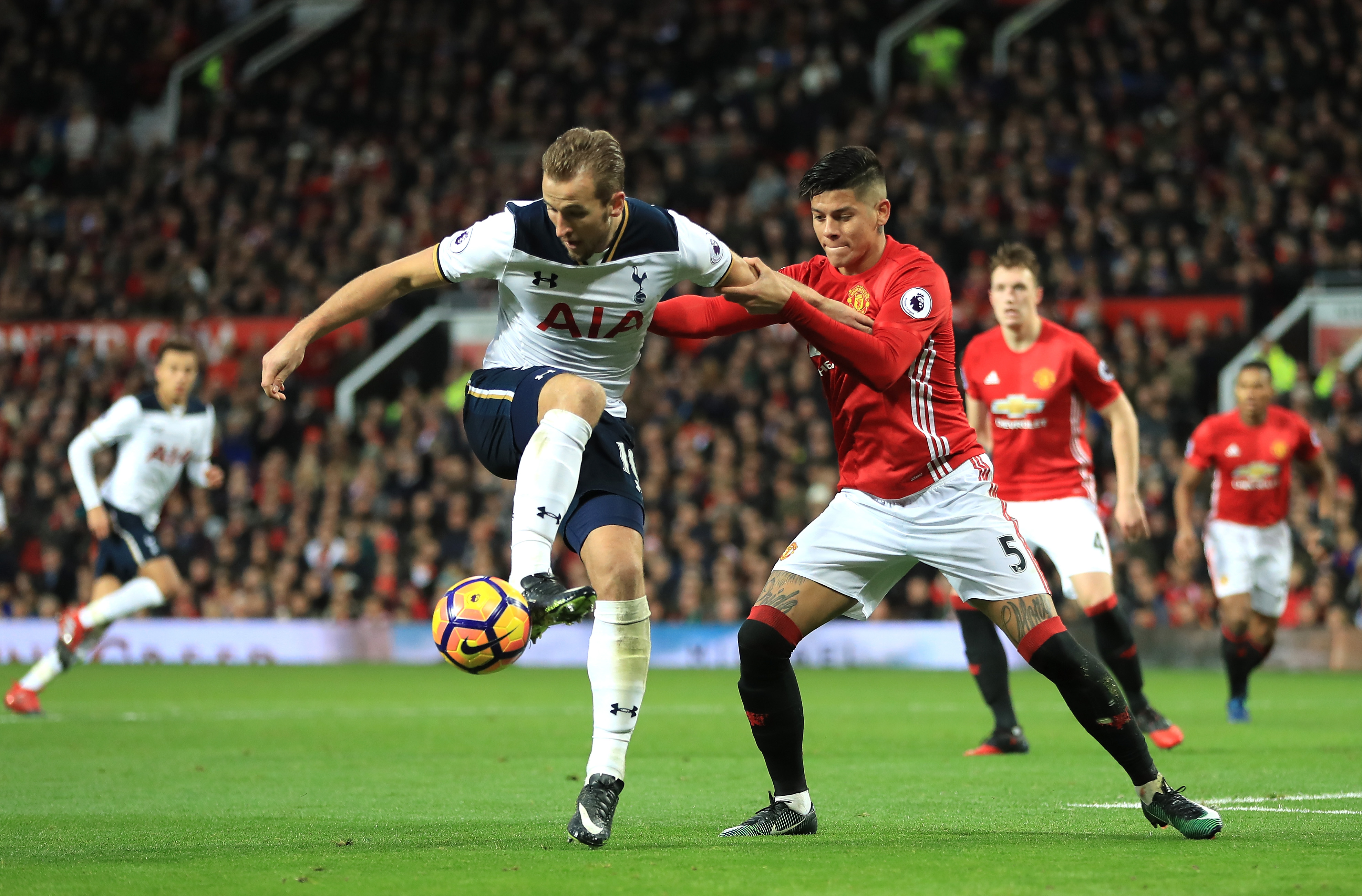 MANCHESTER, ENGLAND - DECEMBER 11: Harry Kane of Tottenham Hotspur controls the ball under pressure of Marcos Rojo of Manchester United during the Premier League match between Manchester United and Tottenham Hotspur at Old Trafford on December 11, 2016 in Manchester, England.  (Photo by Richard Heathcote/Getty Images)