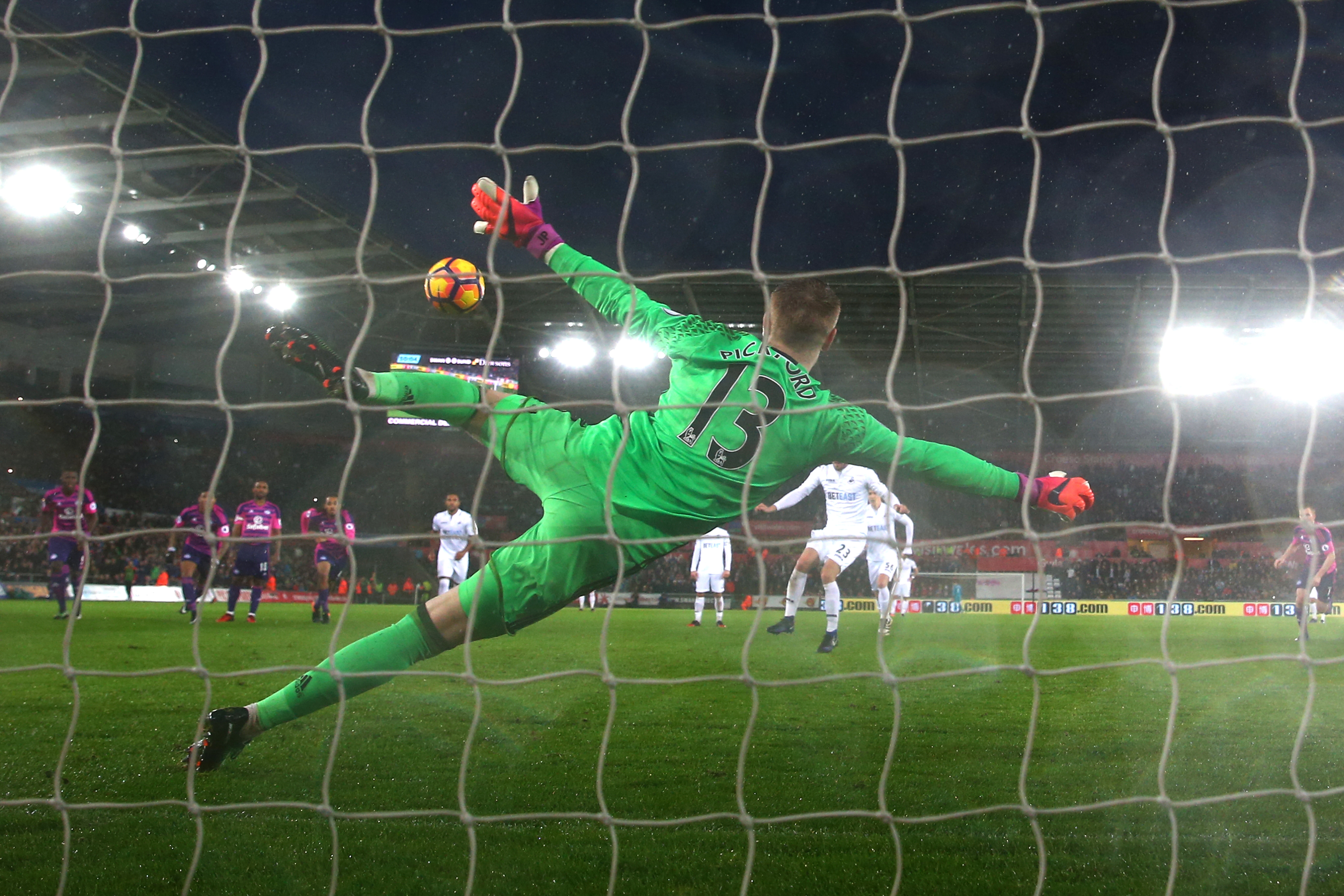 SWANSEA, WALES - DECEMBER 10: Gylfi Sigurdsson of Swansea City (C/obsure) scores his sides first goal past Jordan Pickford of Sunderland (C) from the penalty spot during the Premier League match between Swansea City and Sunderland at the Liberty Stadium on December 10, 2016 in Swansea, Wales.  (Photo by Michael Steele/Getty Images)