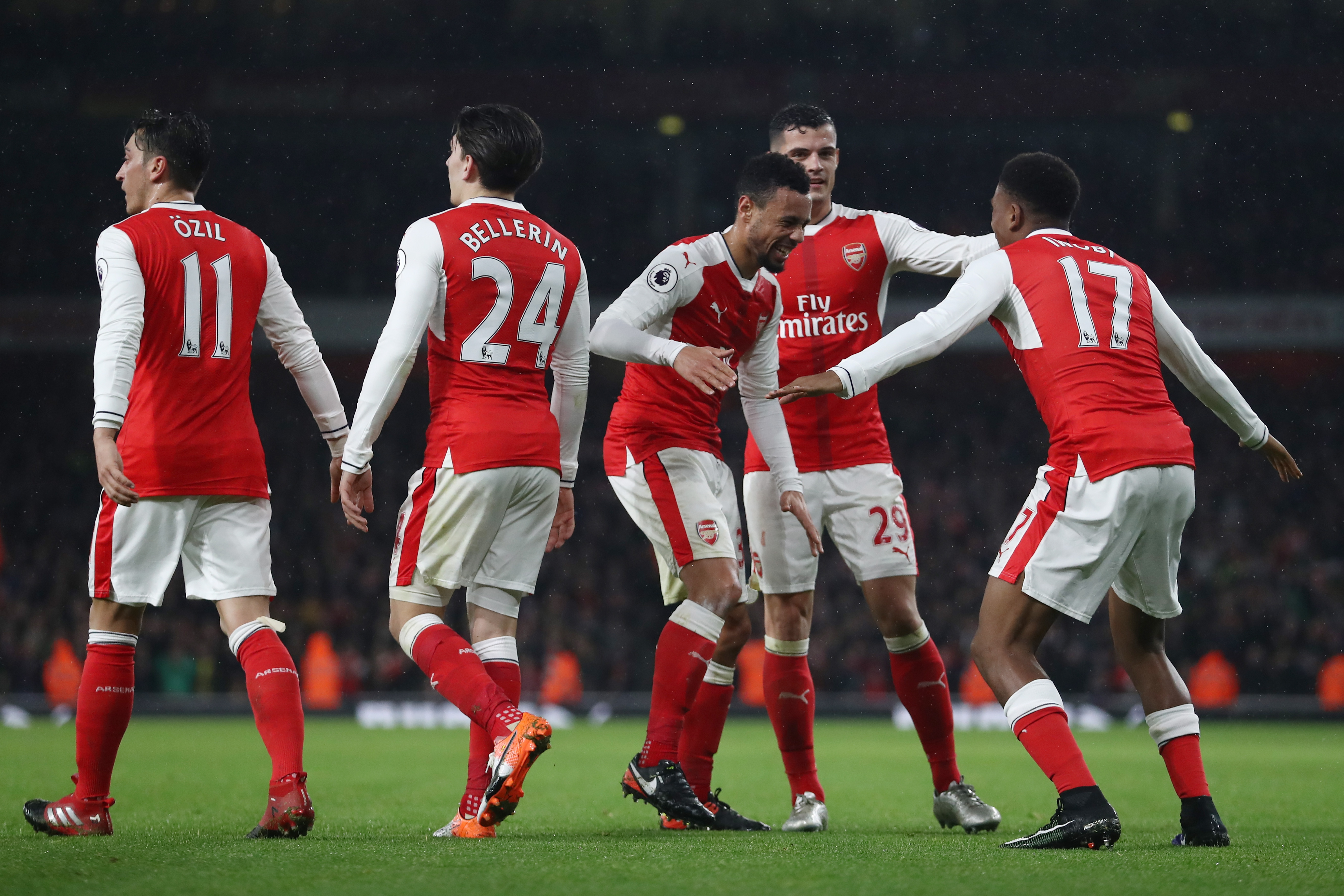 LONDON, ENGLAND - DECEMBER 10:  Alex Iwobi of Arsenal (R) celebrates scoring his sides third goal with his Arsenal team mates during the Premier League match between Arsenal and Stoke City at the Emirates Stadium on December 10, 2016 in London, England.  (Photo by Julian Finney/Getty Images)