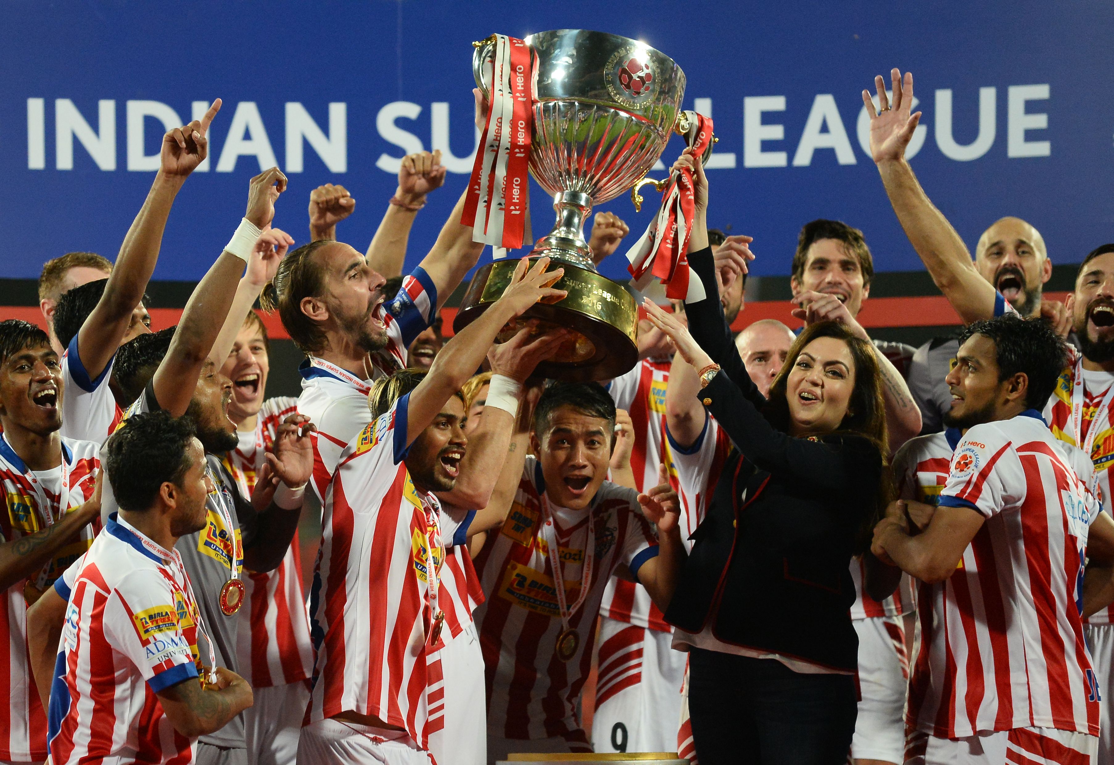 Atletico de Kolkata players celebrate with the trophy, presented by Indian Super League (ISL) director Nita Ambani (3rd R), after winning the ISL final football match against Kerala Blasters FC at the Jawahar Lal Nehru Stadium in Kochi on December 18, 2016. ----IMAGE RESTRICTED TO EDITORIAL USE - STRICTLY NO COMMERCIAL USE-----  / AFP / SAJJAD HUSSAIN        (Photo credit should read SAJJAD HUSSAIN/AFP/Getty Images)