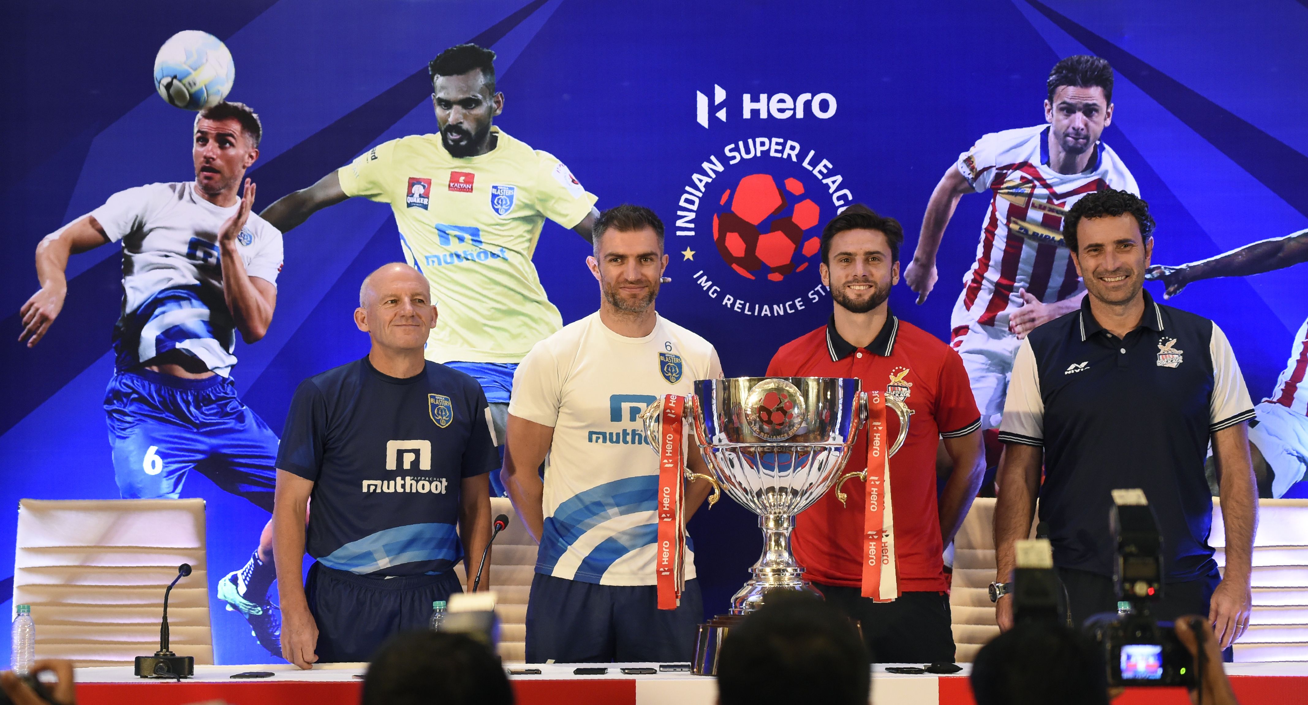 (L/R): Indian Super League (ISL) Kerala Blasters FC football team head coach Steve Coppell, Kerala defender Aaron Hughes,  Atlectico de Kolkata forward Helder Postiga and head coach Jose Francisco Molina pose with the ISL trophy after addressing a pre-match press conference in Kochi on December 17, 2016, ahead of the ISL final between Kerala Blasters FC and Atletico de Kolkata on December 18. ----IMAGE RESTRICTED TO EDITORIAL USE - STRICTLY NO COMMERCIAL USE----- / AFP / SAJJAD HUSSAIN        (Photo credit should read SAJJAD HUSSAIN/AFP/Getty Images)