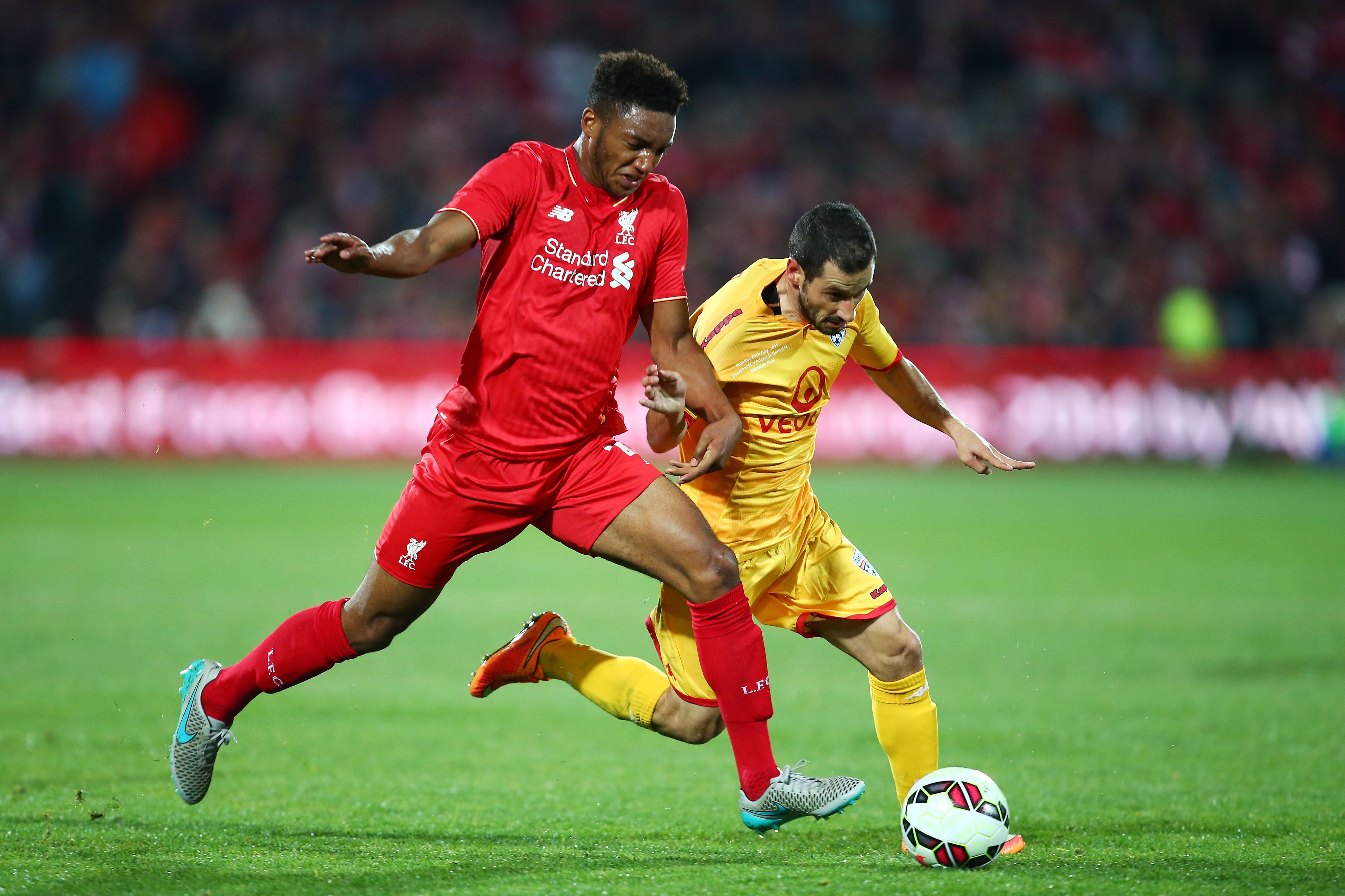 ADELAIDE, AUSTRALIA - JULY 20:  Sergio Cirio of United is challenged by Joe Gomez of Liverpool during the international friendly match between Adelaide United and Liverpool FC at Adelaide Oval on July 20, 2015 in Adelaide, Australia.  (Photo by Matt King/Getty Images)