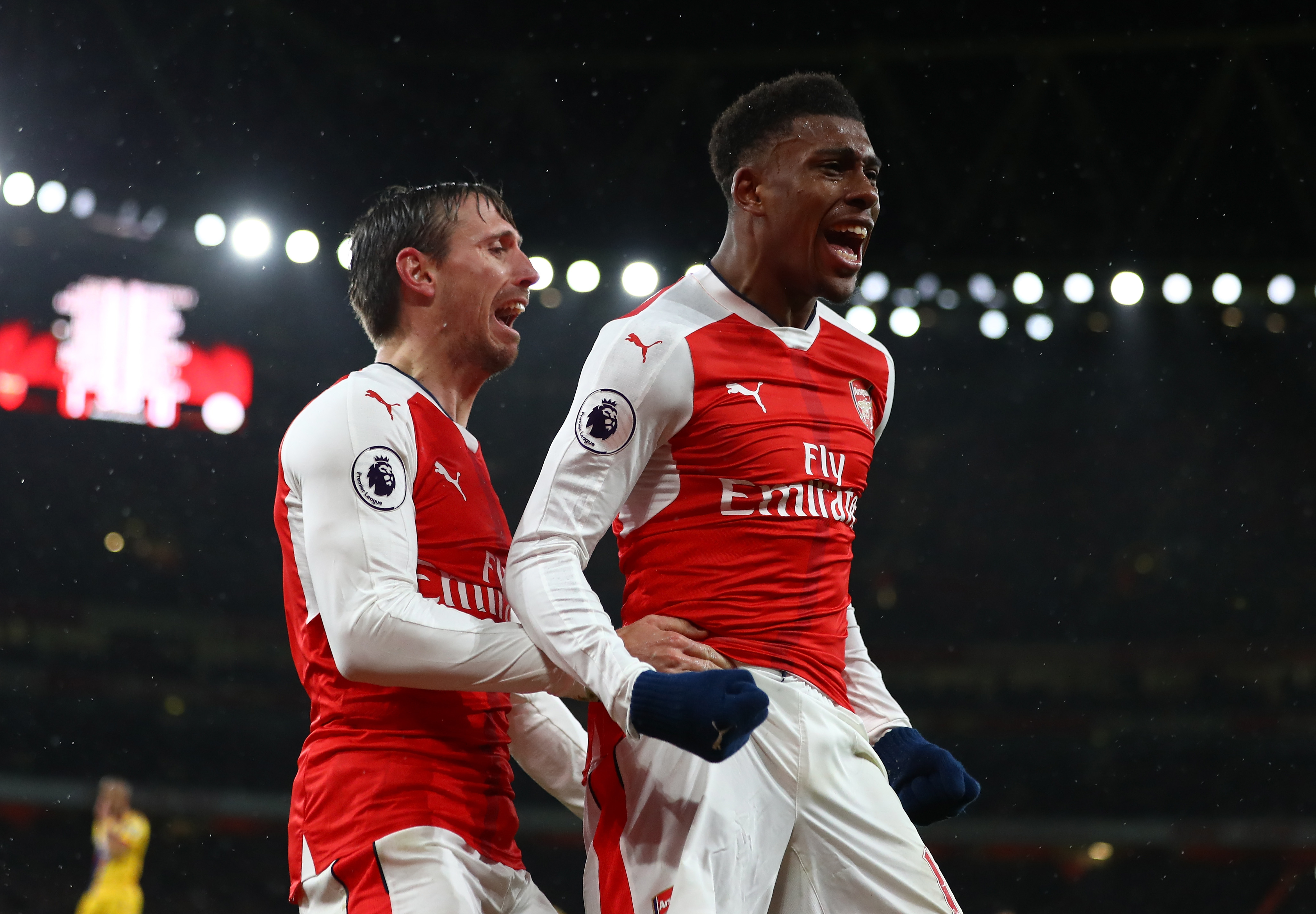 LONDON, ENGLAND - JANUARY 01:  Alex Iwobi of Arsenal celebrates with teammate Nacho Monreal (L) after scoring his team's second goal during the Premier League match between Arsenal and Crystal Palace at the Emirates Stadium on January 1, 2017 in London, England.  (Photo by Clive Mason/Getty Images)