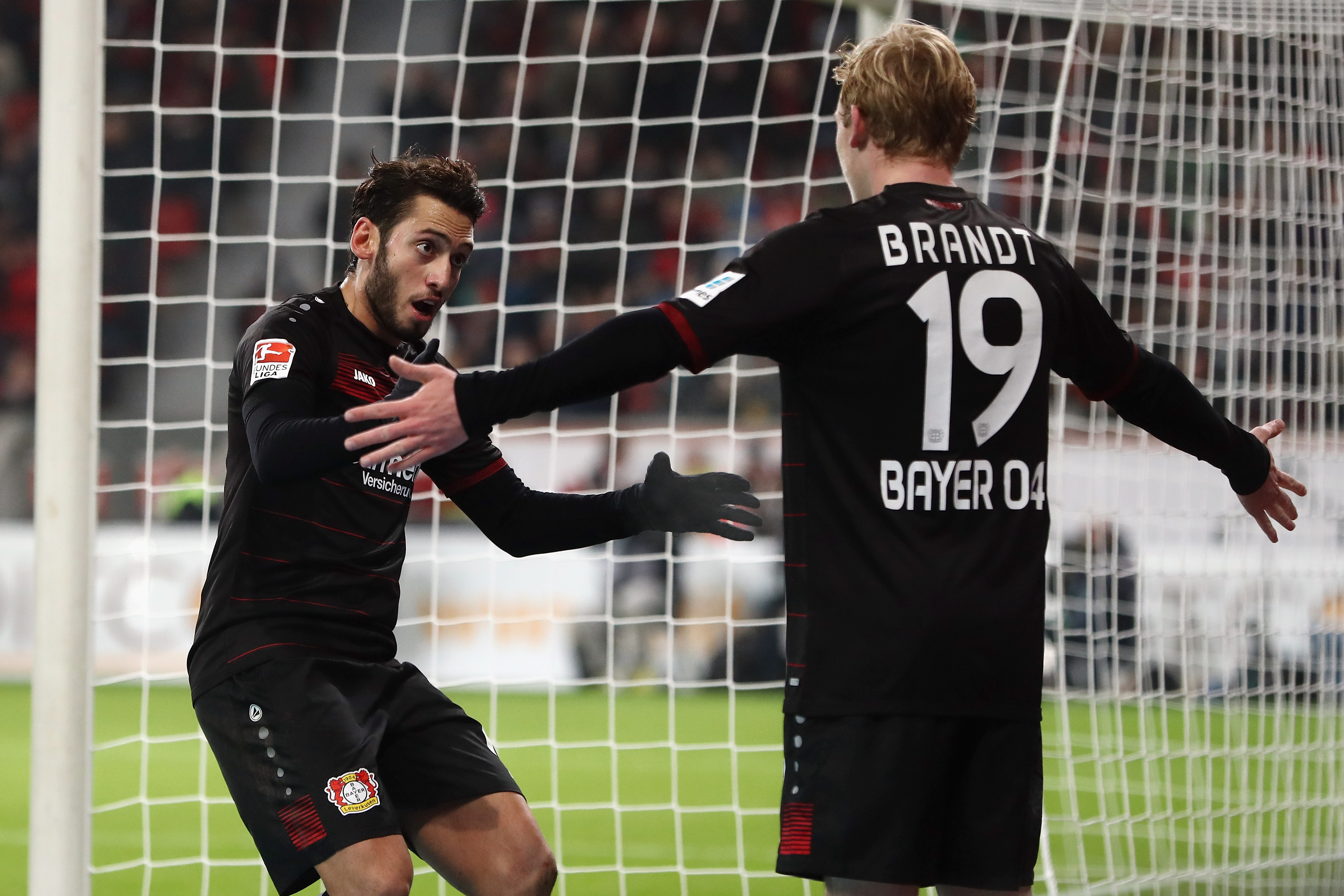 LEVERKUSEN, GERMANY - DECEMBER 03:  Hakan Calhanoglu of Leverkusen celebrates his team's first goal with team mate Julian Brandt during the Bundesliga match between Bayer 04 Leverkusen and SC Freiburg at BayArena on December 3, 2016 in Leverkusen, Germany.  (Photo by Alex Grimm/Bongarts/Getty Images)