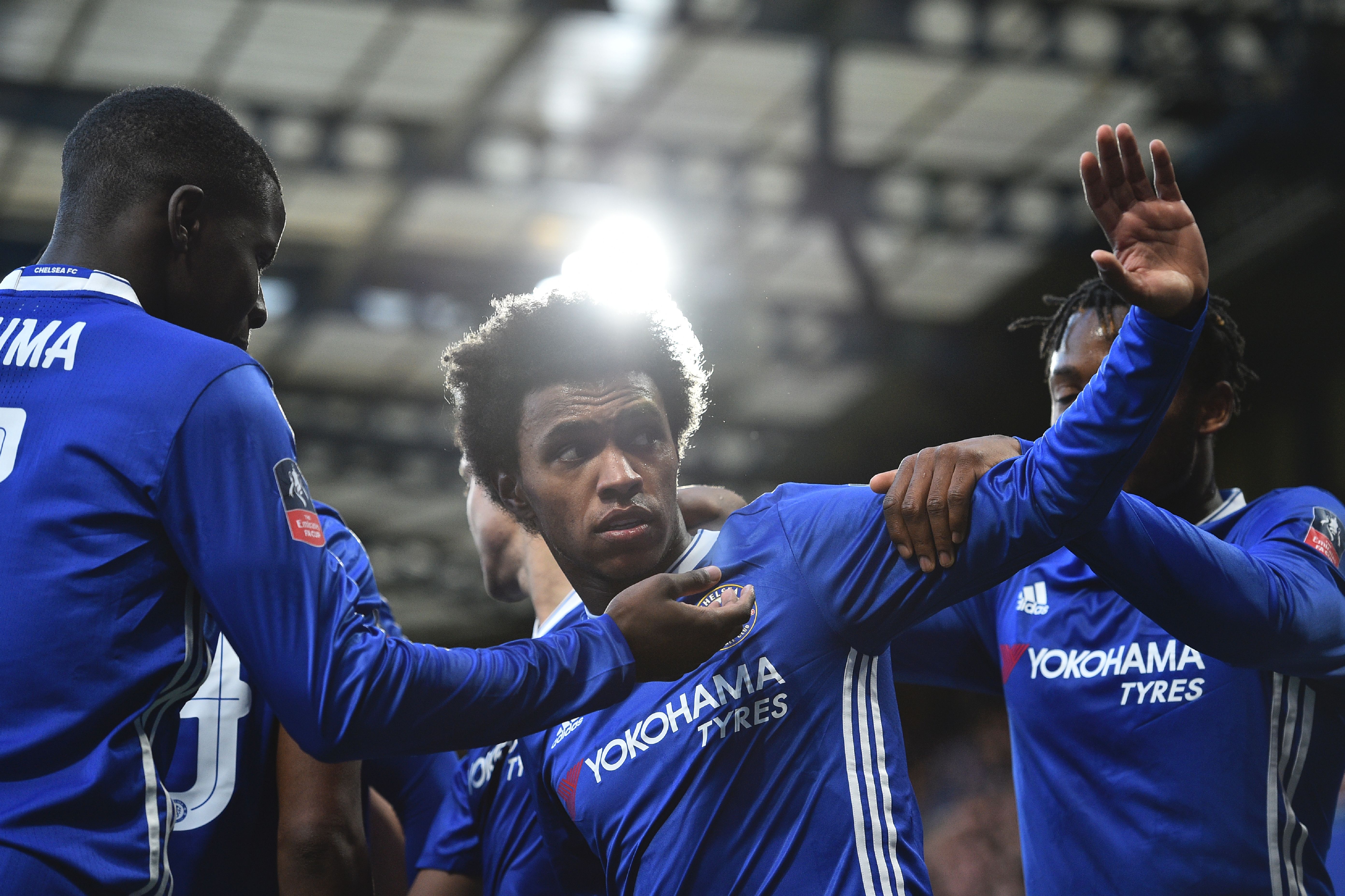 Chelsea's Brazilian midfielder Willian (C) celebrates scoring the opening goal during the English FA Cup fourth round football match between Chelsea and Brentford at Stamford Bridge in London on January 28, 2017. / AFP / Glyn KIRK / RESTRICTED TO EDITORIAL USE. No use with unauthorized audio, video, data, fixture lists, club/league logos or 'live' services. Online in-match use limited to 75 images, no video emulation. No use in betting, games or single club/league/player publications.  /         (Photo credit should read GLYN KIRK/AFP/Getty Images)