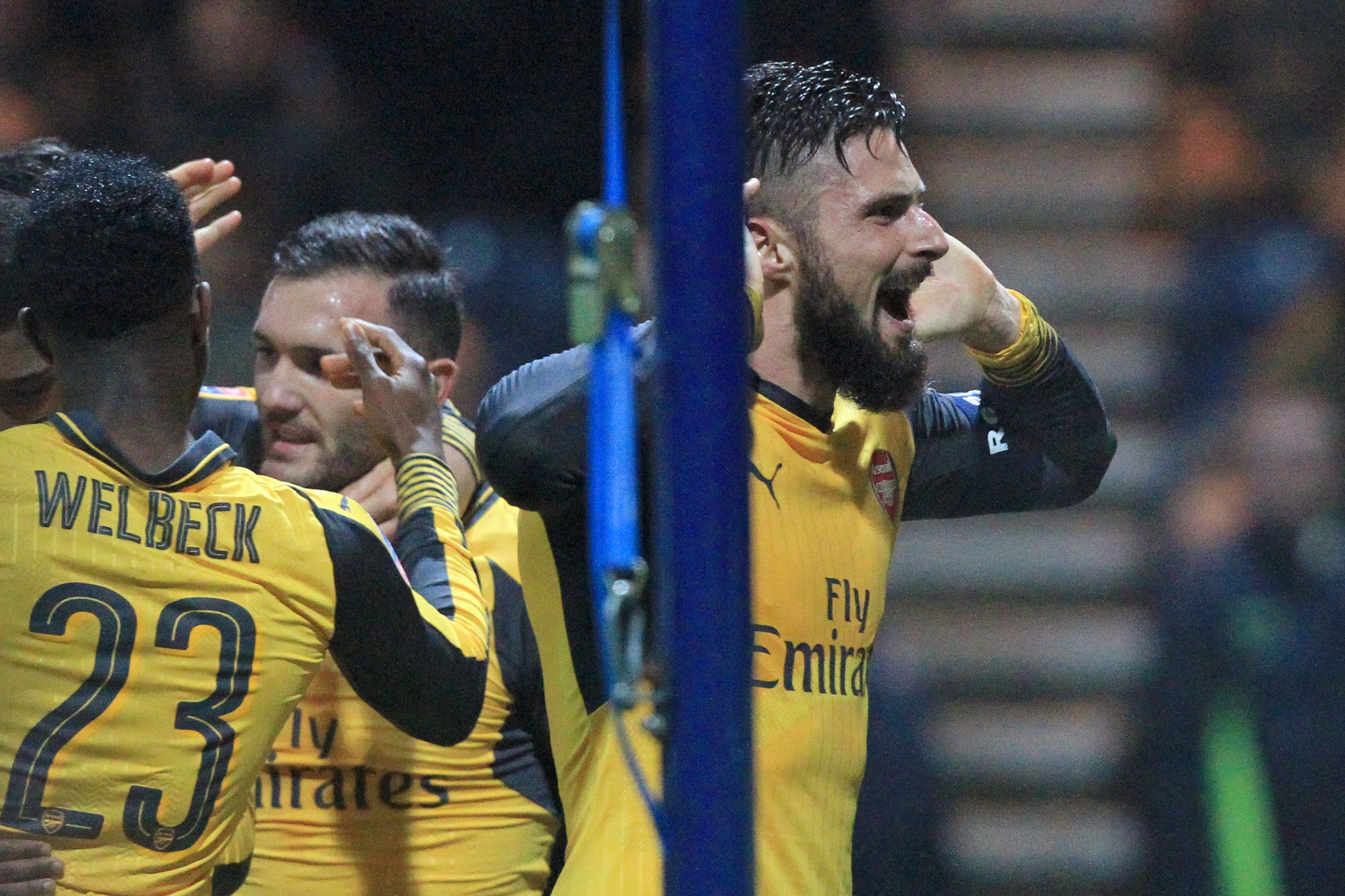 Arsenal's French striker Olivier Giroud (R) celebrates after scoring their second goal during the English FA Cup third round football match between Preston North End and Arsenal at Deepdale in north west England on January 7, 2017.
Arsenal won the game 2-1. / AFP / Lindsey PARNABY / RESTRICTED TO EDITORIAL USE. No use with unauthorized audio, video, data, fixture lists, club/league logos or 'live' services. Online in-match use limited to 75 images, no video emulation. No use in betting, games or single club/league/player publications.  /         (Photo credit should read LINDSEY PARNABY/AFP/Getty Images)