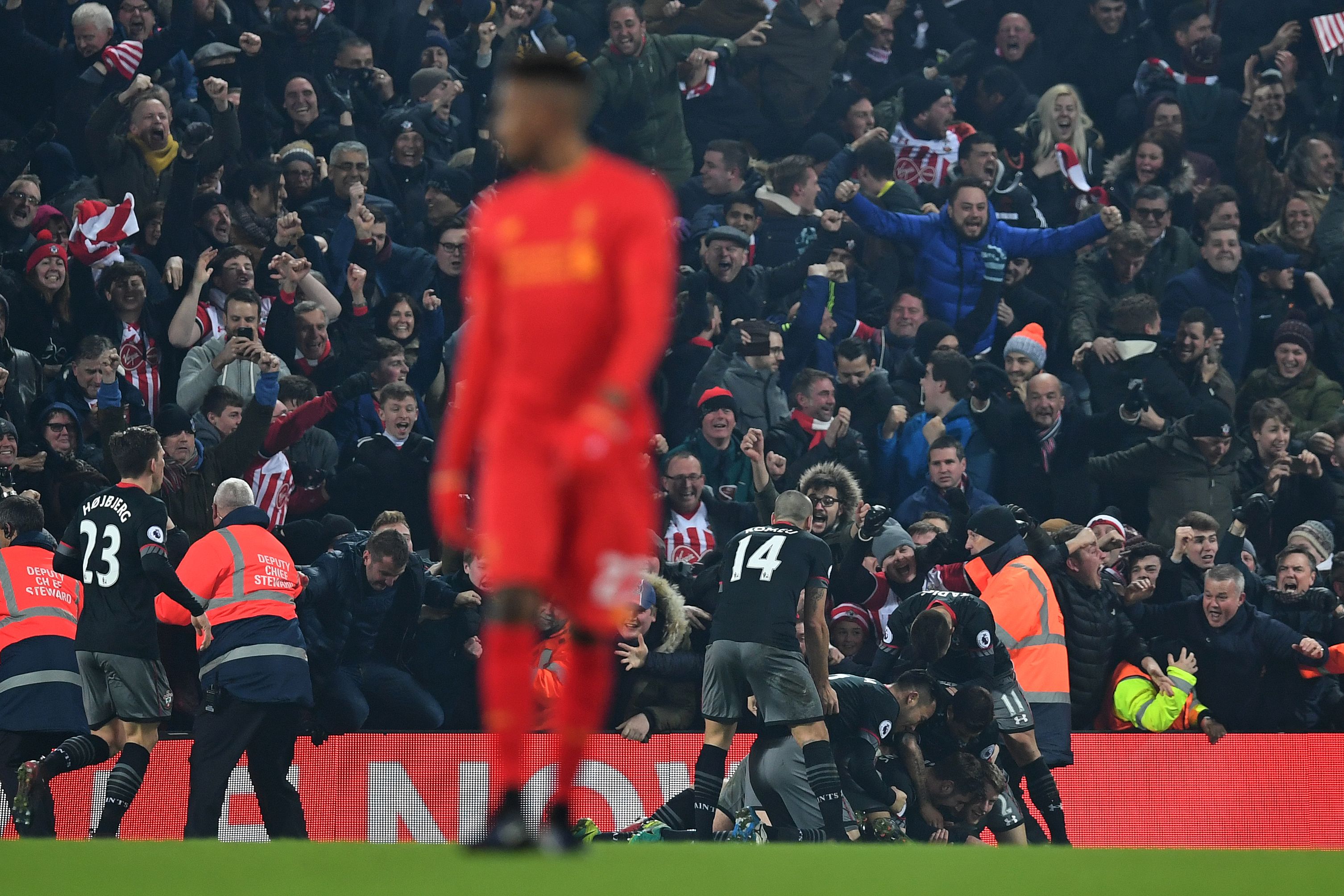 Southampton's Irish striker Shane Long (R) is mobbed by teammates as he celebrates scoring his team's first goal during the EFL (English Football League) Cup semi-final second-leg football match between Liverpool and Southampton at Anfield in Liverpool, north west England on January 25, 2017.
Southampton won the match 1-0. / AFP / Paul ELLIS / RESTRICTED TO EDITORIAL USE. No use with unauthorized audio, video, data, fixture lists, club/league logos or 'live' services. Online in-match use limited to 75 images, no video emulation. No use in betting, games or single club/league/player publications.  /         (Photo credit should read PAUL ELLIS/AFP/Getty Images)