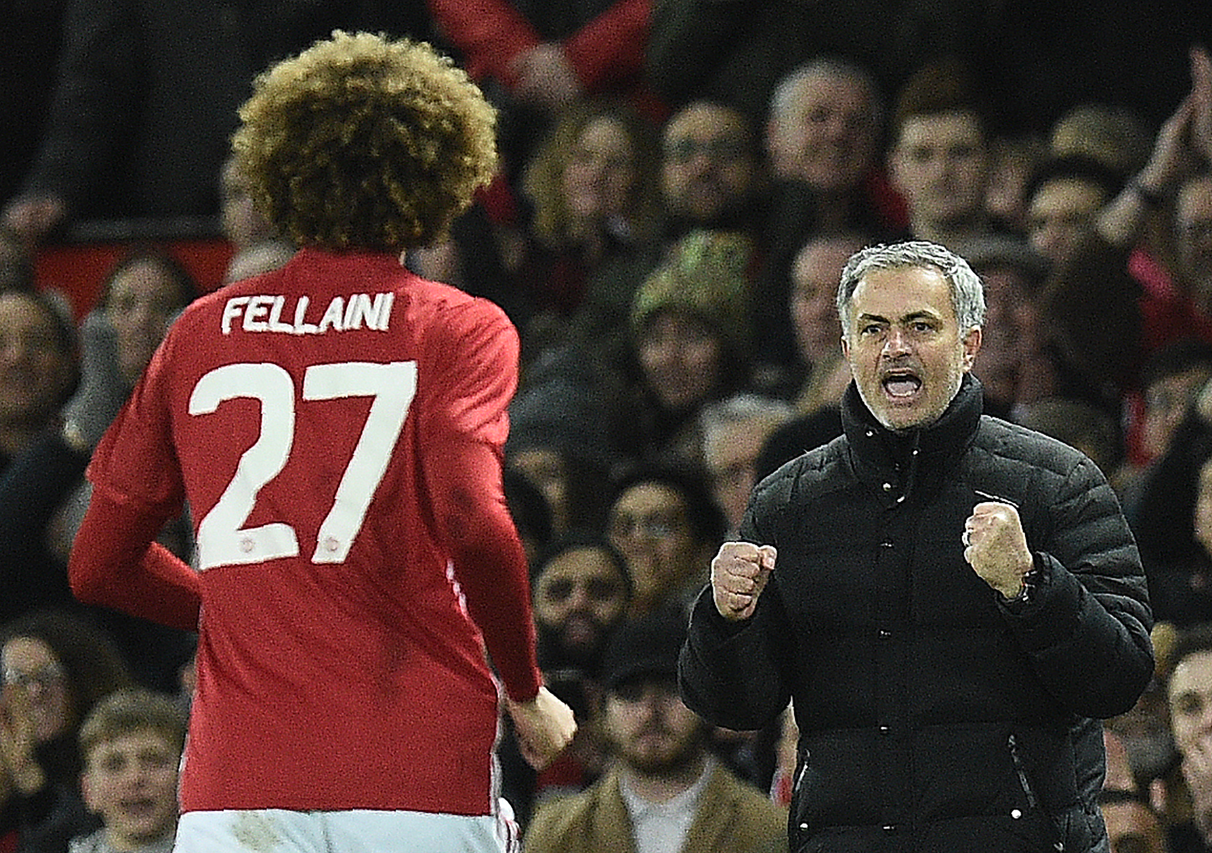 Manchester United's Belgian midfielder Marouane Fellaini (L) celebrates scoring his team's second goal with Manchester United's Portuguese manager Jose Mourinho during the EFL (English Football League) Cup semi-final football match between Manchester United and Hull City at Old Trafford in Manchester, north west England on January 10, 2017. / AFP / Oli SCARFF / RESTRICTED TO EDITORIAL USE. No use with unauthorized audio, video, data, fixture lists, club/league logos or 'live' services. Online in-match use limited to 75 images, no video emulation. No use in betting, games or single club/league/player publications.  /         (Photo credit should read OLI SCARFF/AFP/Getty Images)