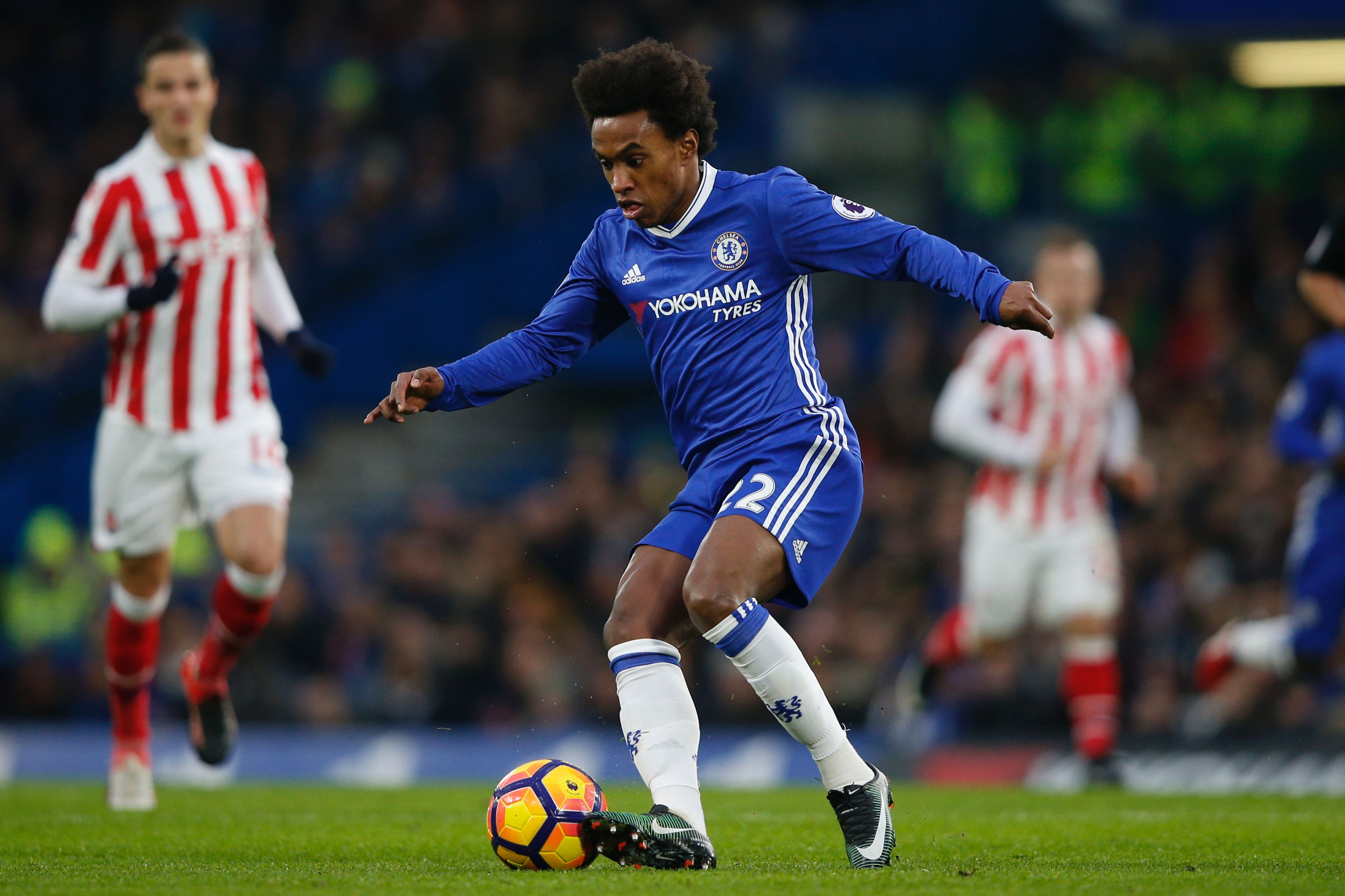 Chelsea's Brazilian midfielder Willian controls the ball during the English Premier League football match between Chelsea and Stoke City at Stamford Bridge in London on December 31, 2016. / AFP / Adrian DENNIS / RESTRICTED TO EDITORIAL USE. No use with unauthorized audio, video, data, fixture lists, club/league logos or 'live' services. Online in-match use limited to 75 images, no video emulation. No use in betting, games or single club/league/player publications.  /         (Photo credit should read ADRIAN DENNIS/AFP/Getty Images)