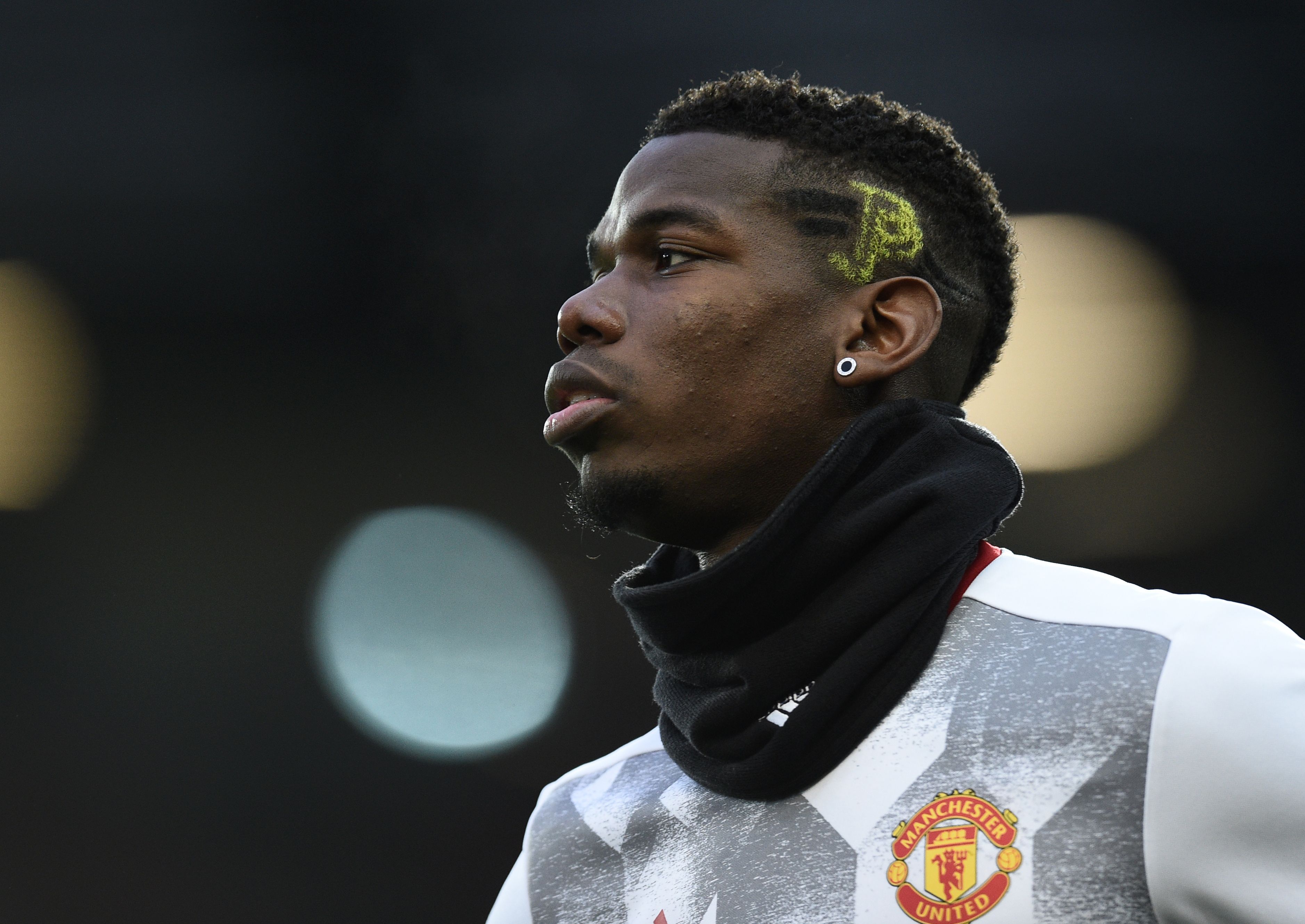 Manchester United's French midfielder Paul Pogba warms up ahead of the English Premier League football match between Manchester United and Liverpool at Old Trafford in Manchester, north west England, on January 15, 2017. / AFP / Oli SCARFF / RESTRICTED TO EDITORIAL USE. No use with unauthorized audio, video, data, fixture lists, club/league logos or 'live' services. Online in-match use limited to 75 images, no video emulation. No use in betting, games or single club/league/player publications.  /         (Photo credit should read OLI SCARFF/AFP/Getty Images)