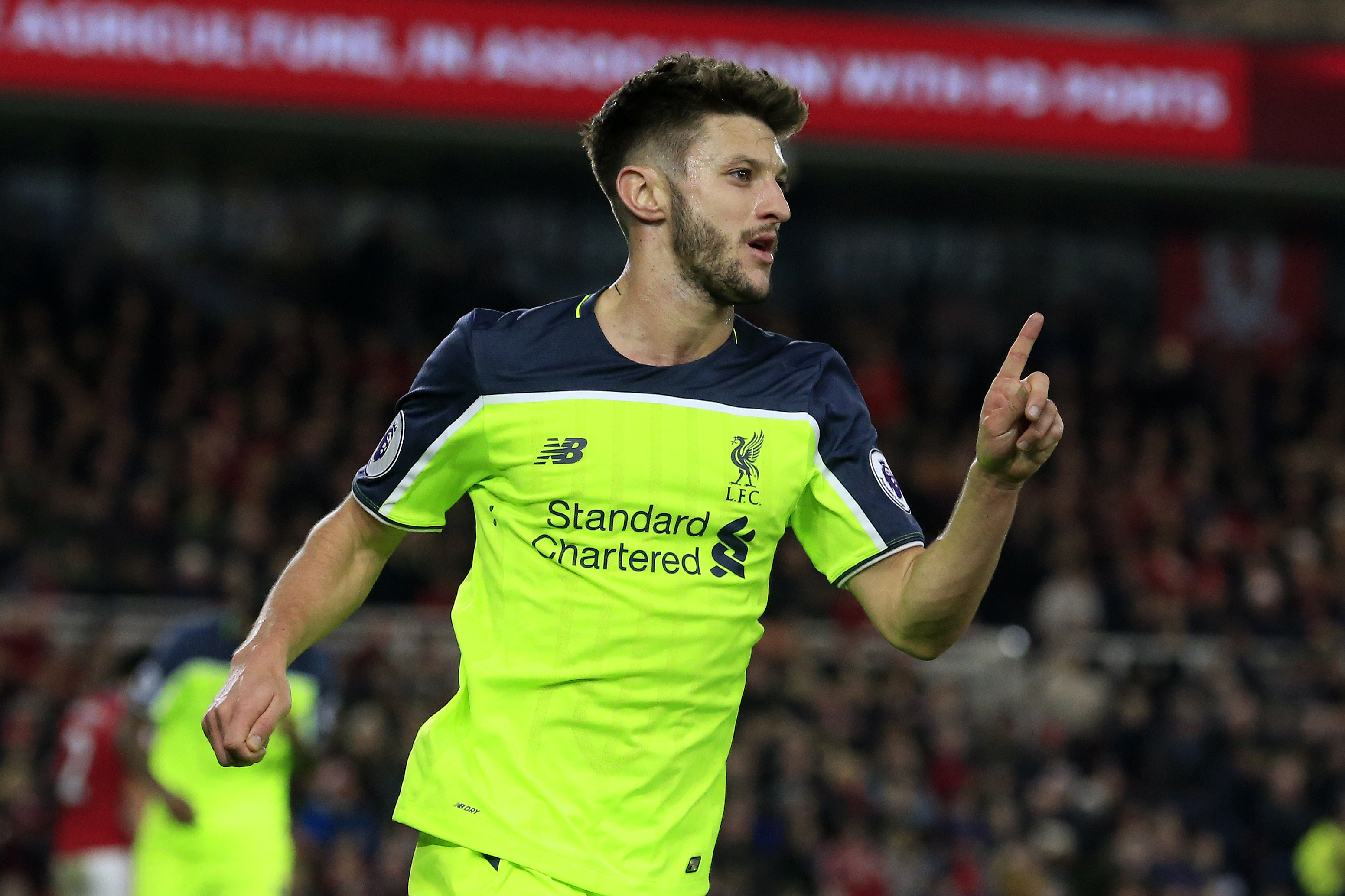 Liverpool's English midfielder Adam Lallana celebrates scoring his team's third goal during the English Premier League football match between Middlesbrough and Liverpool at Riverside Stadium in Middlesbrough, northeast England on December 14, 2016. / AFP / Lindsey PARNABY / RESTRICTED TO EDITORIAL USE. No use with unauthorized audio, video, data, fixture lists, club/league logos or 'live' services. Online in-match use limited to 75 images, no video emulation. No use in betting, games or single club/league/player publications.  /         (Photo credit should read LINDSEY PARNABY/AFP/Getty Images)