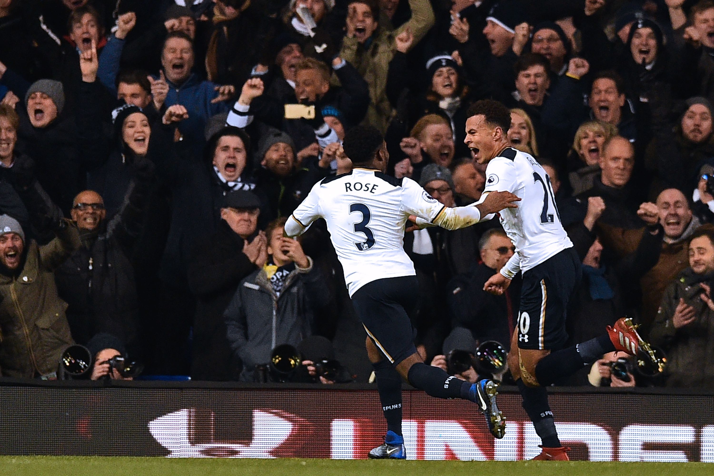 Tottenham Hotspur's English midfielder Dele Alli celebrates with Tottenham Hotspur's English defender Danny Rose (L) after scoring the opening goal of the English Premier League football match between Tottenham Hotspur and Chelsea at White Hart Lane in London, on January 4, 2017.       (Photo credit should read IKIMAGES/AFP/Getty Images)