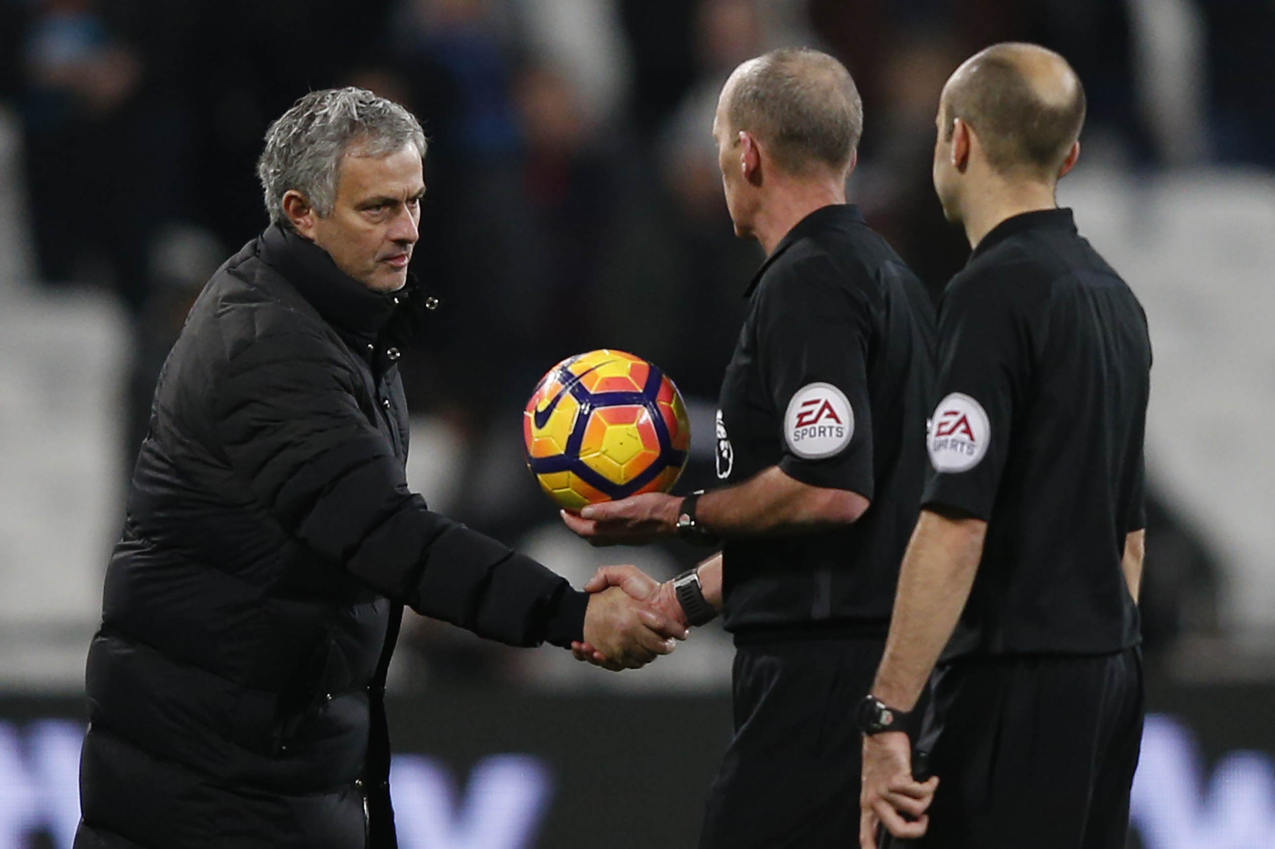 Manchester United's Portuguese manager Jose Mourinho (L) shakes hands with referee Mike Dean on the pitch after the English Premier League football match between West Ham United and Manchester United at The London Stadium, in east London on January 2, 2017.
Manchester United won the game 2-0. / AFP / Adrian DENNIS / RESTRICTED TO EDITORIAL USE. No use with unauthorized audio, video, data, fixture lists, club/league logos or 'live' services. Online in-match use limited to 75 images, no video emulation. No use in betting, games or single club/league/player publications.  /         (Photo credit should read ADRIAN DENNIS/AFP/Getty Images)