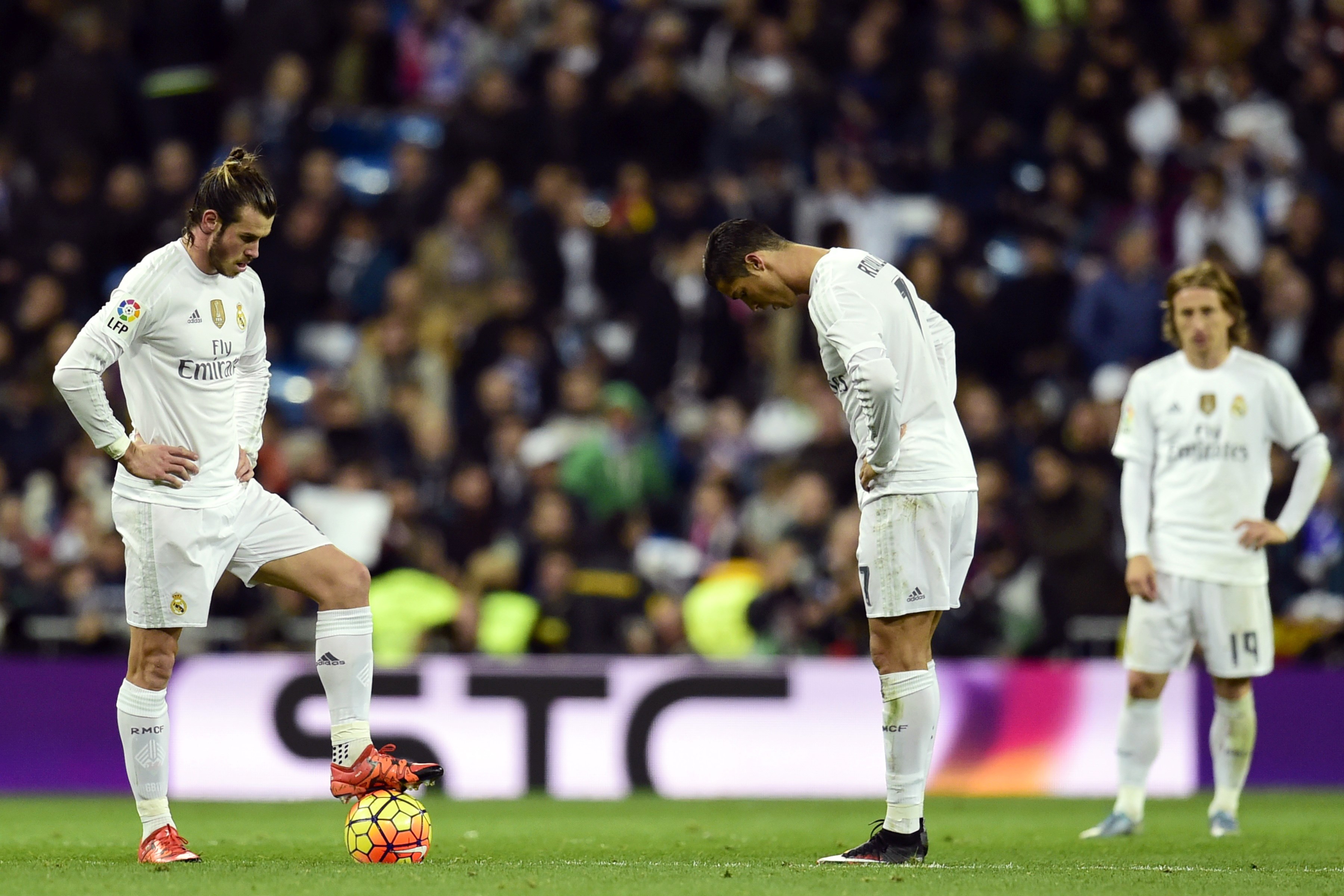 Real Madrid's Welsh forward Gareth Bale, Real Madrid's Portuguese forward Cristiano Ronaldo and Real Madrid's Croatian midfielder Luka Modric stand during the Spanish league "Clasico" football match Real Madrid CF vs FC Barcelona at the Santiago Bernabeu stadium in Madrid on November 21, 2015. AFP PHOTO/ JAVIER SORIANO        (Photo credit should read JAVIER SORIANO/AFP/Getty Images)