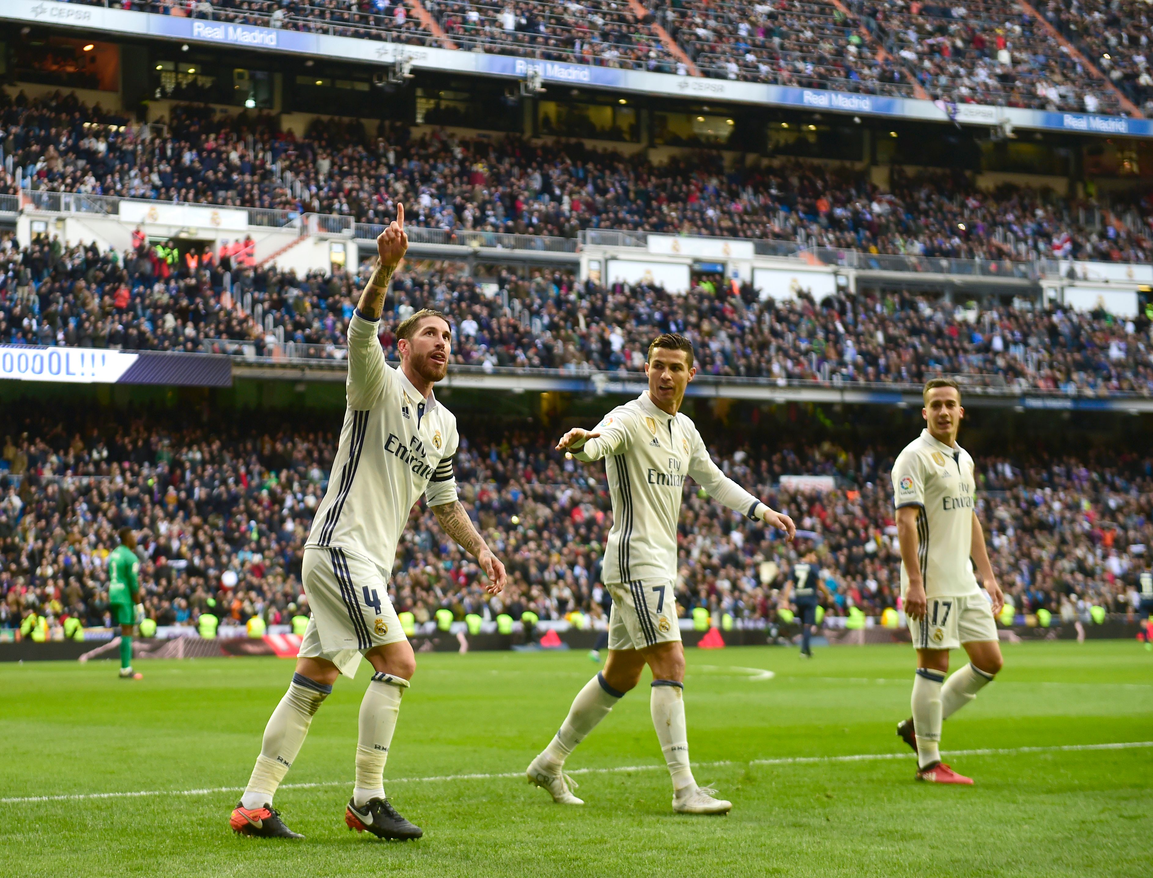 Real Madrid's defender Sergio Ramos (L) celebrates after scoring during the Spanish league football match Real Madrid CF vs Malaga CF at the Santiago Bernabeu stadium in Madrid on January 21, 2017. / AFP / PIERRE-PHILIPPE MARCOU        (Photo credit should read PIERRE-PHILIPPE MARCOU/AFP/Getty Images)