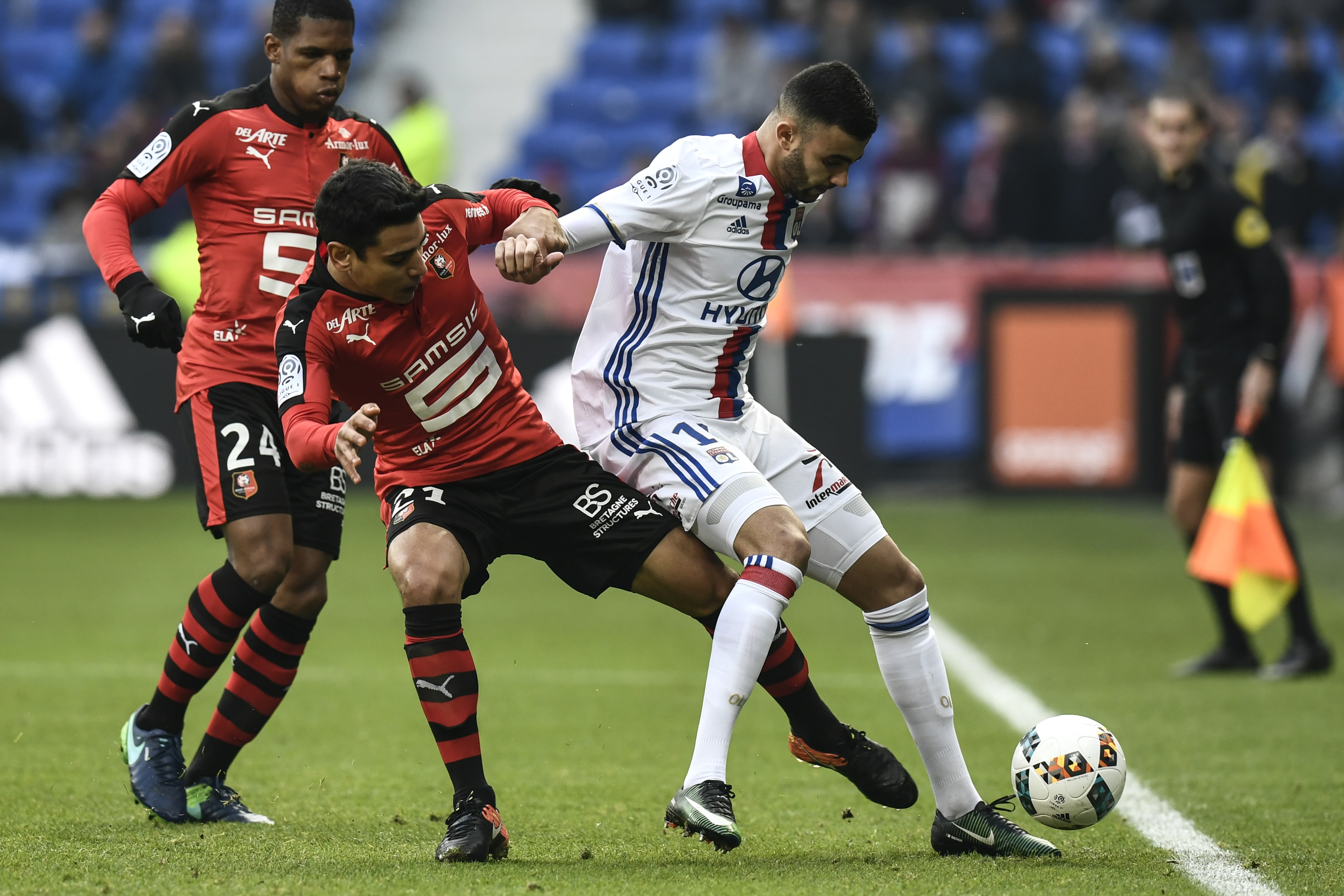Rennes' French midfielder Benjamin Andre (2ndL) vies with Lyon's French Algerian midfielder Rachid Ghezzal (R)  during the French L1 football match Olympique Lyonnais (OL) vs Rennes (Stade Rennais) on December 11, 2016 at the Parc Olympique Lyonnais stadium in Decines-Charpieu, central-eastern France.  / AFP / JEFF PACHOUD        (Photo credit should read JEFF PACHOUD/AFP/Getty Images)