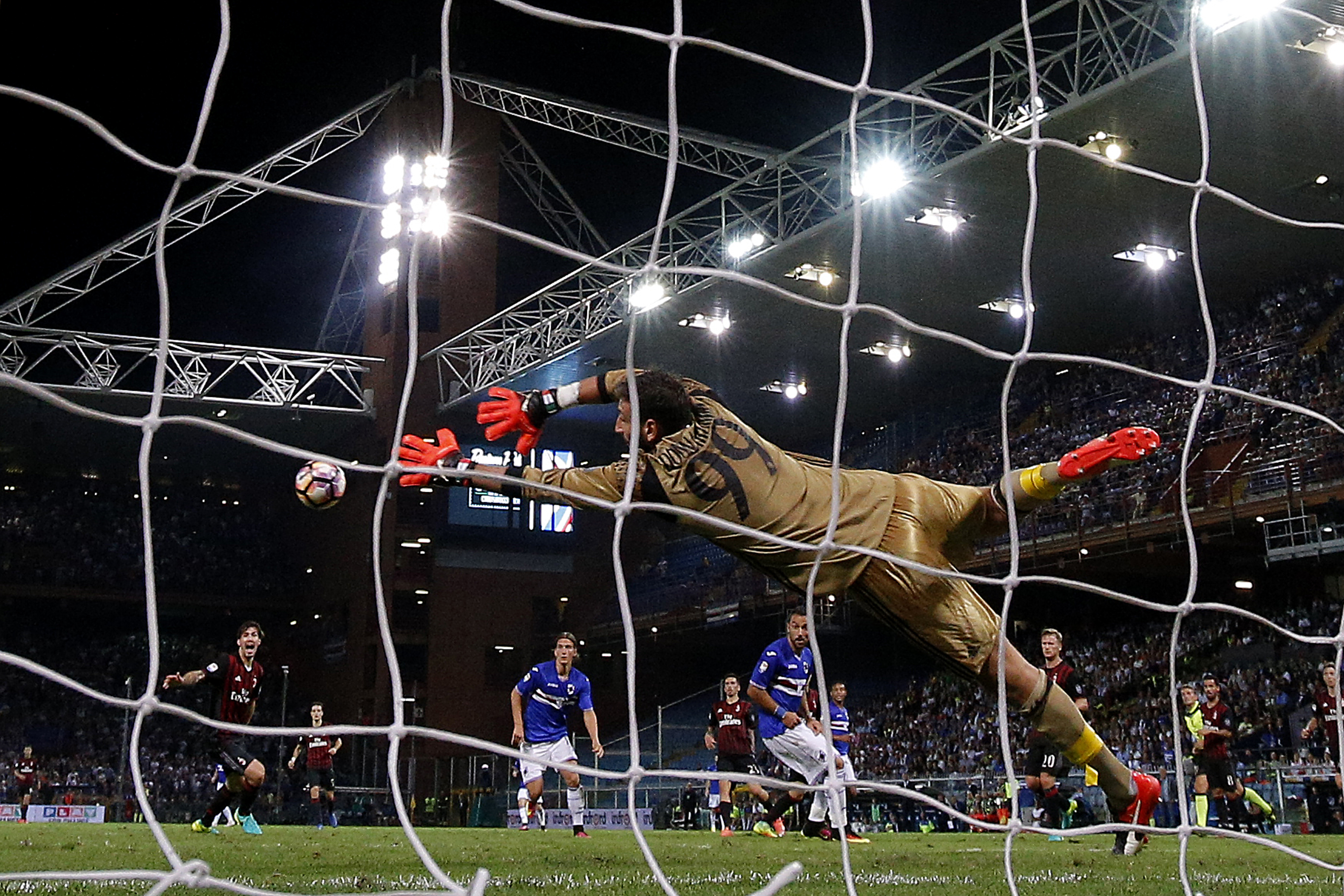 AC Milan's goalkeeper Gianluigi Donnarumma tries to block the ball during the Italian Serie A football match between Sampdoria and AC Milan on September 16, 2016 at 'Luigi Ferraris Stadium' in Genoa.  / AFP / MARCO BERTORELLO        (Photo credit should read MARCO BERTORELLO/AFP/Getty Images)