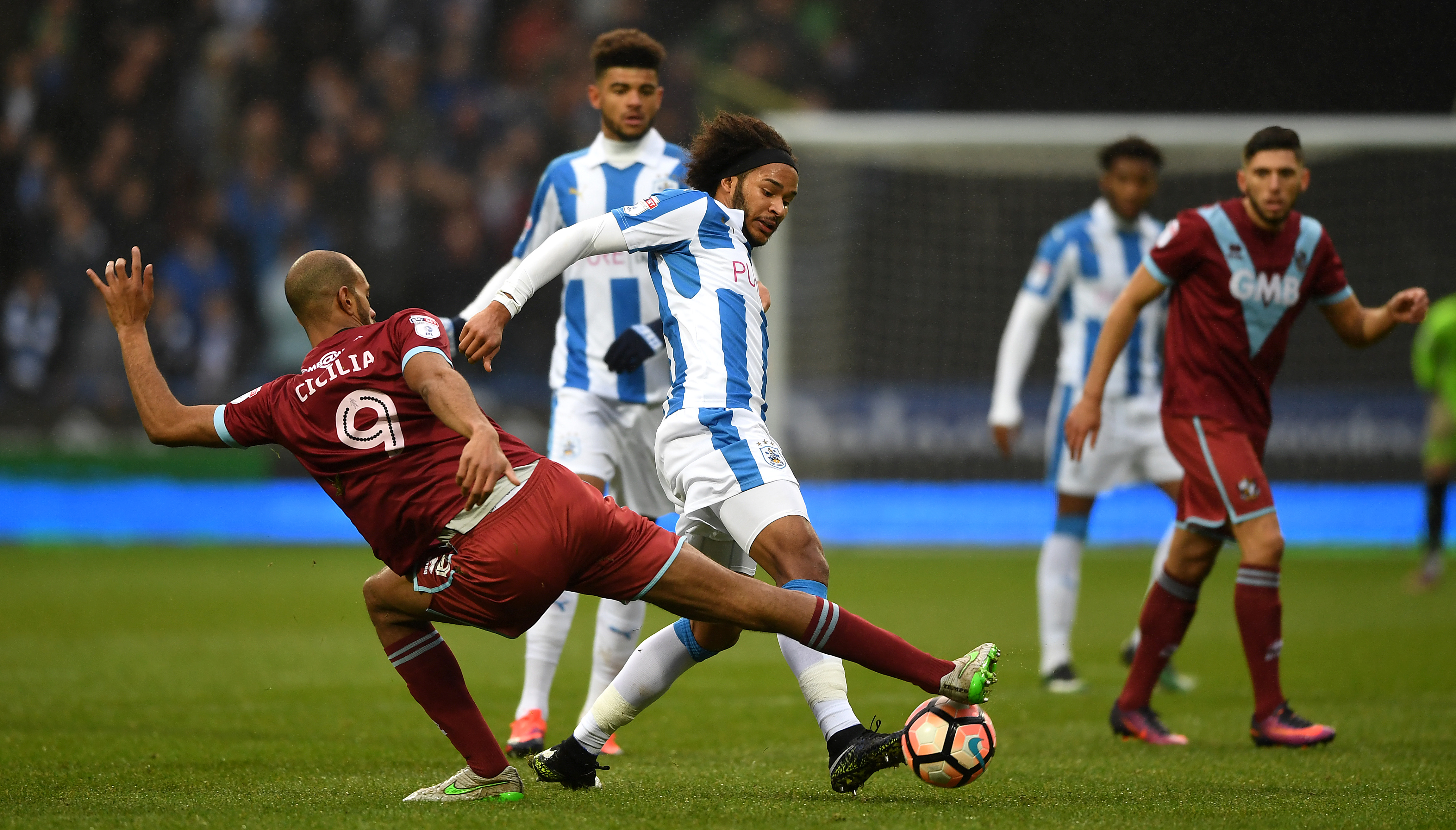 HUDDERSFIELD, ENGLAND - JANUARY 07:  Isaiah Brown of Huddersfield is tackled by Rigino Cicilia of Port Vale during The Emirates FA Cup Third Round match between Huddersfield Town and Port Vale at Galpharm Stadium on January 7, 2017 in Huddersfield, England.  (Photo by Gareth Copley/Getty Images)