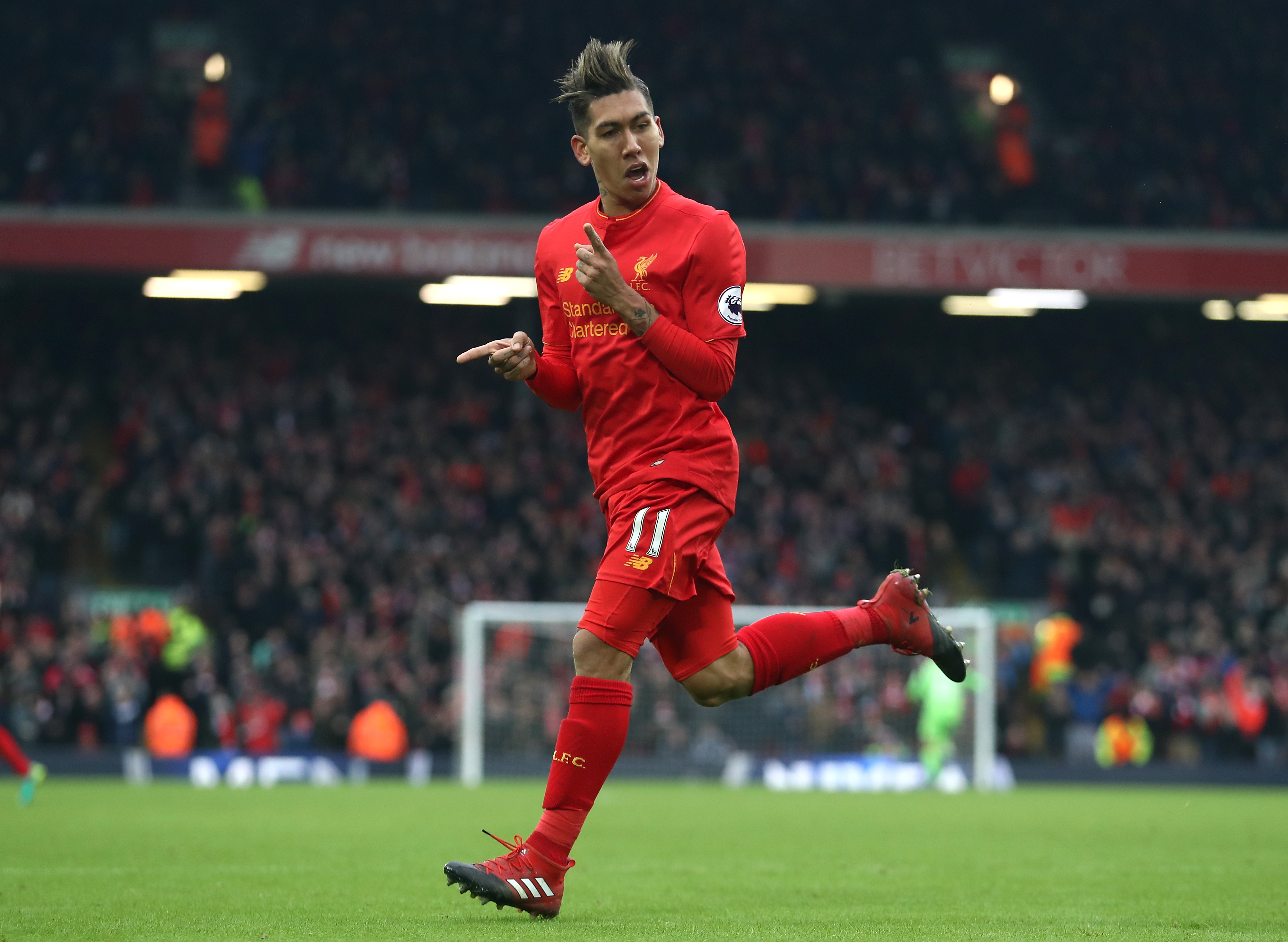 LIVERPOOL, ENGLAND - JANUARY 21: Roberto Firmino of Liverpool celebrates scoring his sides second goal during the Premier League match between Liverpool and Swansea City at Anfield on January 21, 2017 in Liverpool, England.  (Photo by Julian Finney/Getty Images)