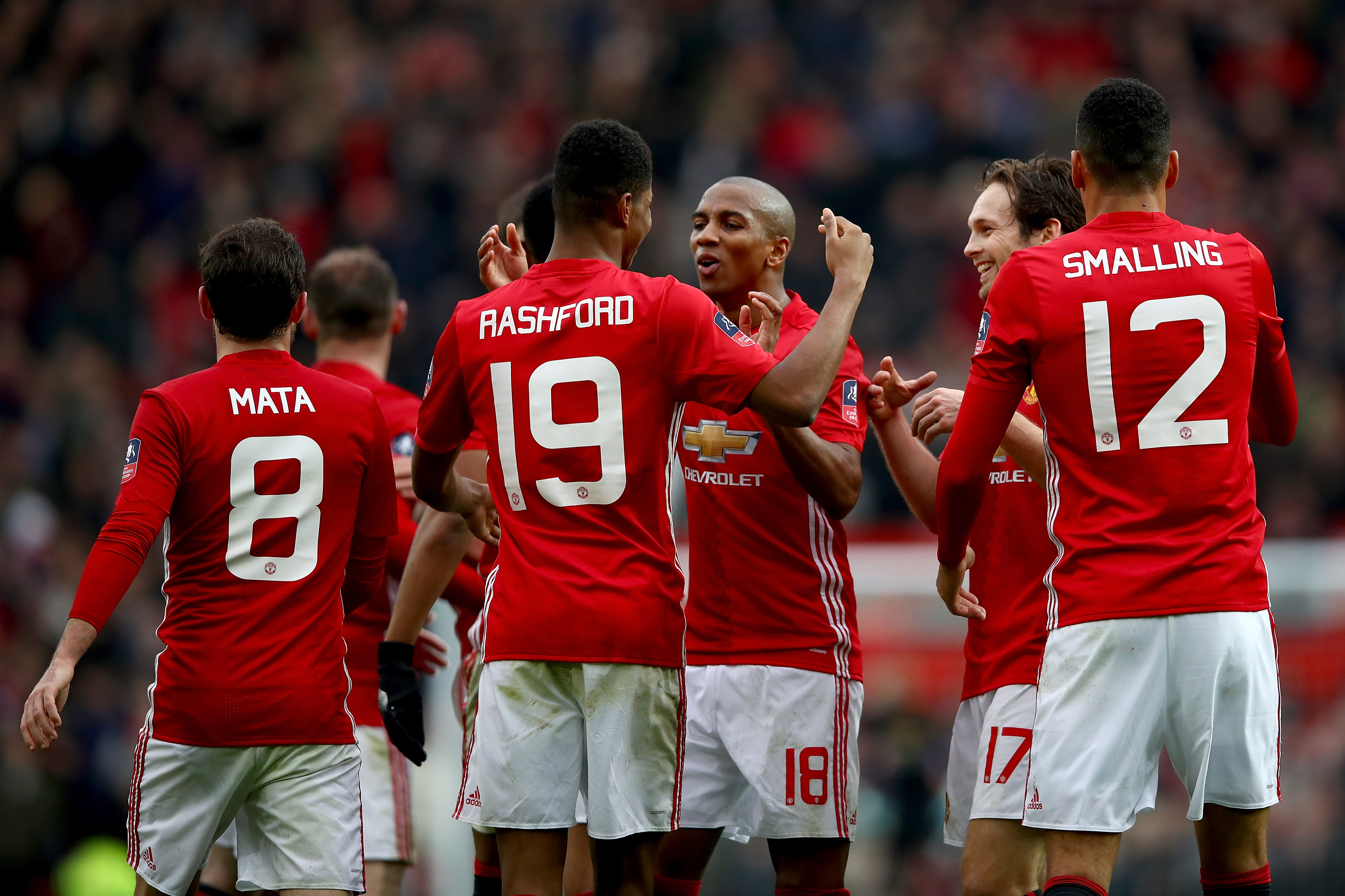 MANCHESTER, ENGLAND - JANUARY 07: Marcus Rashford of Manchester United celebrates with team mates after scoring his first and his sides fourth during the Emirates FA Cup third round match between Manchester United and Reading at Old Trafford on January 7, 2017 in Manchester, England.  (Photo by Clive Brunskill/Getty Images)