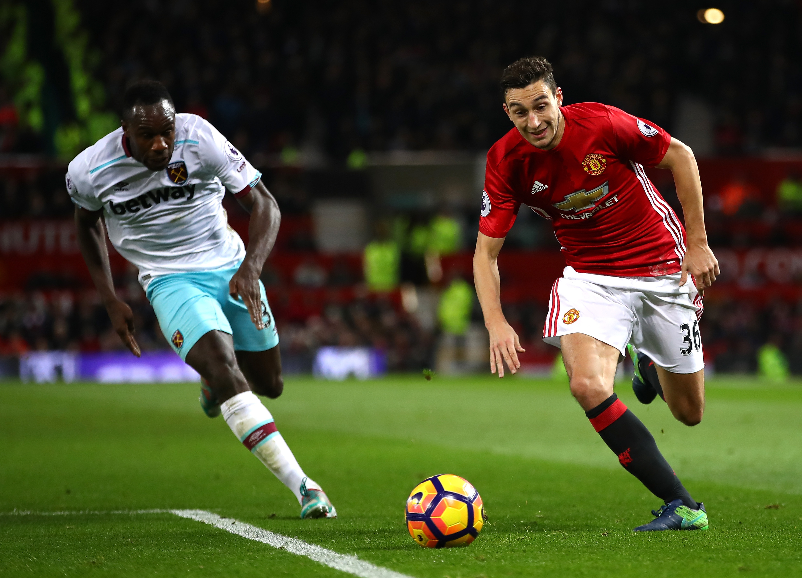 MANCHESTER, ENGLAND - NOVEMBER 27: Michail Antonio of West Ham United (L) and Matteo Darmian of Manchester United (R) chase after the ball during the Premier League match between Manchester United and West Ham United at Old Trafford on November 27, 2016 in Manchester, England.  (Photo by Clive Brunskill/Getty Images)
