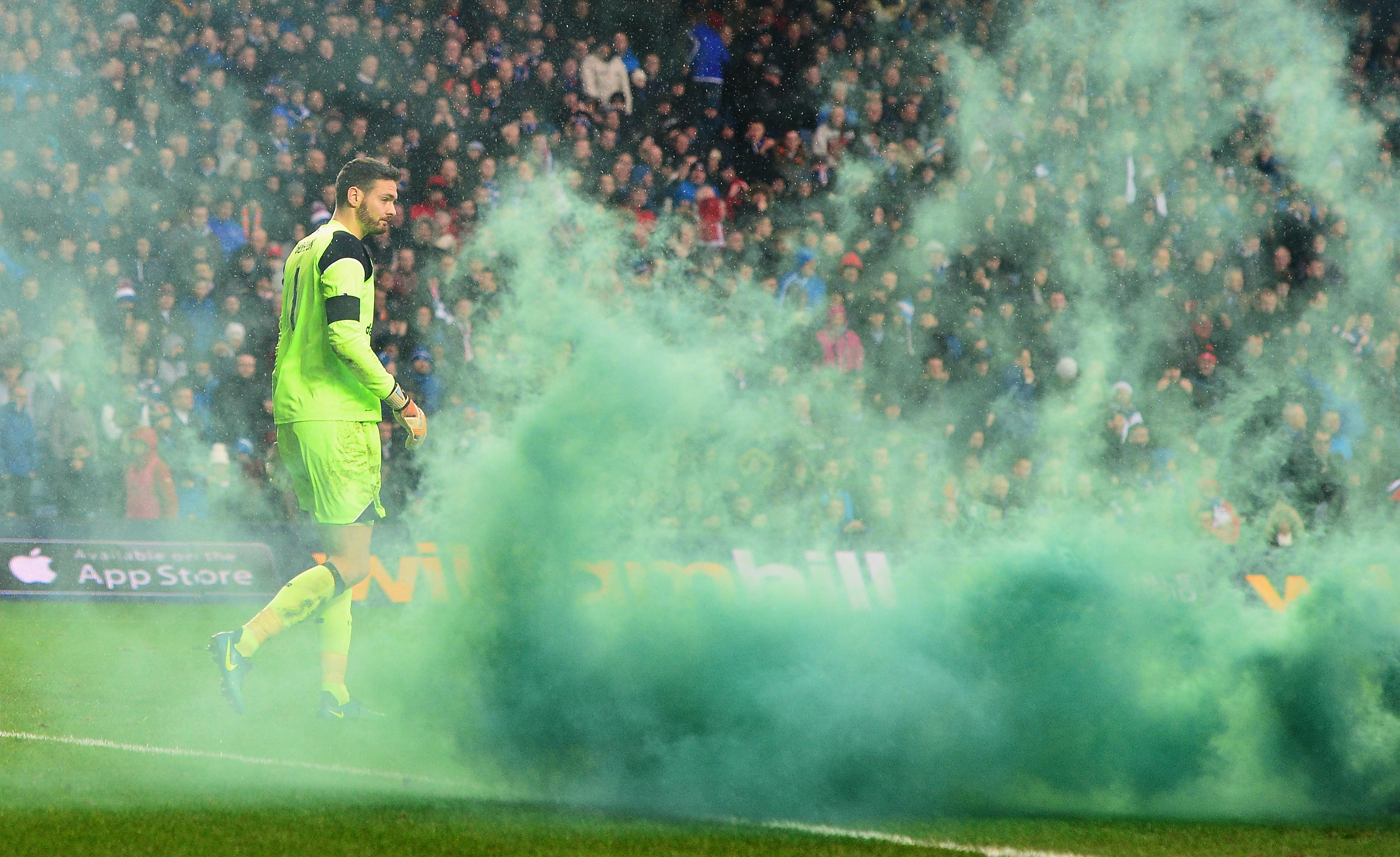 GLASGOW, SCOTLAND - DECEMBER 31:  Craig Gordon of Celtic walks among smokes as a flare is thrown in after Celtic's first goal during the Ladbrokes Scottish Premiership match between Rangers and Celtic at Ibrox Stadium on December 31, 2016 in Glasgow, Scotland.  (Photo by Mark Runnacles/Getty Images)