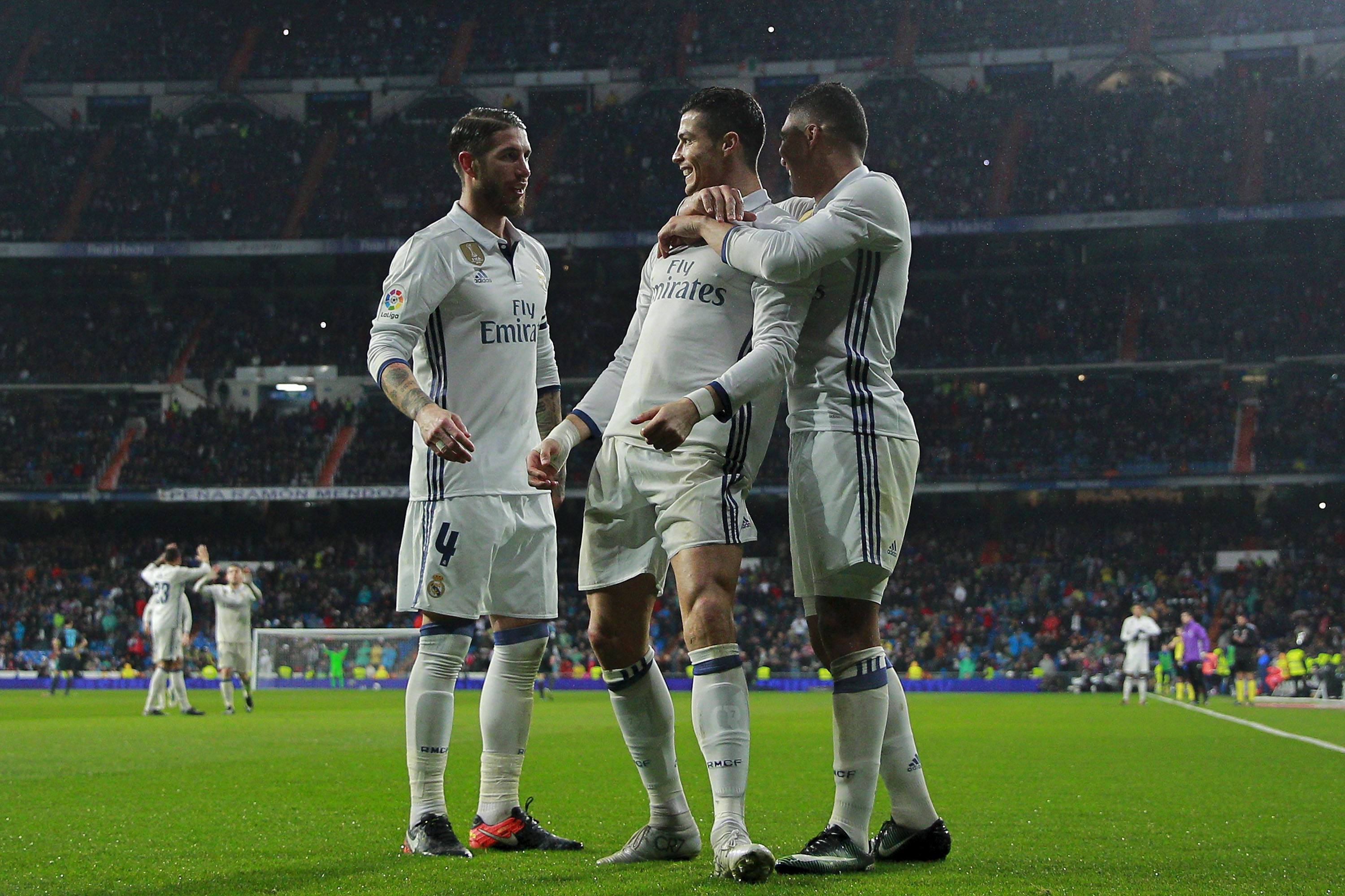 MADRID, SPAIN - JANUARY 29:  Cristiano Ronaldo (2ndR) celebrates scoring their second goal with teammate Carlos Casemiro (R) and Sergio Ramos (L) during the La Liga match between Real Madrid CF and Real Sociedad de Futbol at Estadio Santiago Bernabeu on January 29, 2017 in Madrid, Spain.  (Photo by Gonzalo Arroyo Moreno/Getty Images)