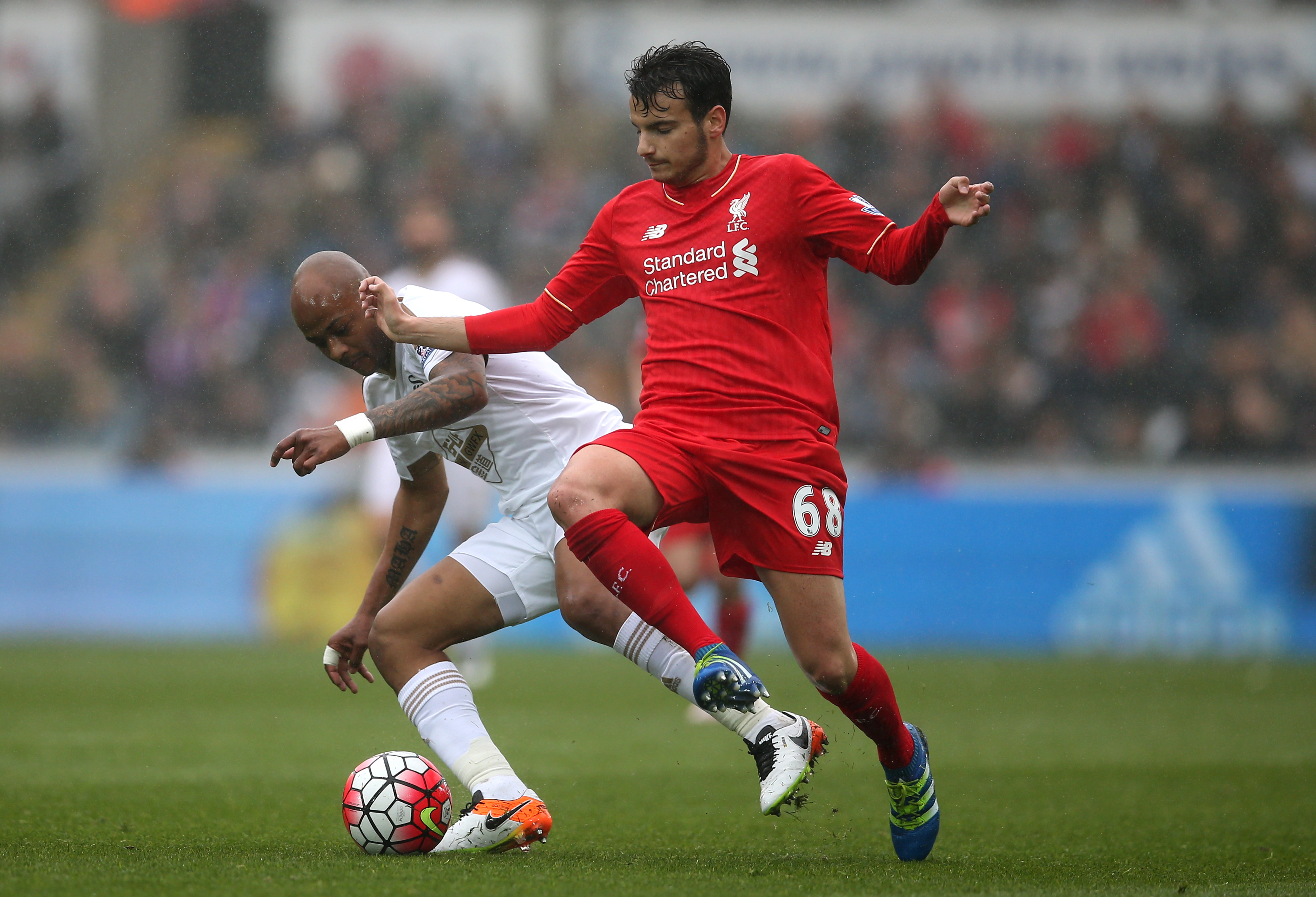 SWANSEA, WALES - MAY 01: Pedro Chirivella of Liverpool is closed down by Andre Ayew of Swansea City during the Barclays Premier League match between Swansea City and Liverpool at The Liberty Stadium on May 1, 2016 in Swansea, Wales.  (Photo by Steve Bardens/Getty Images)