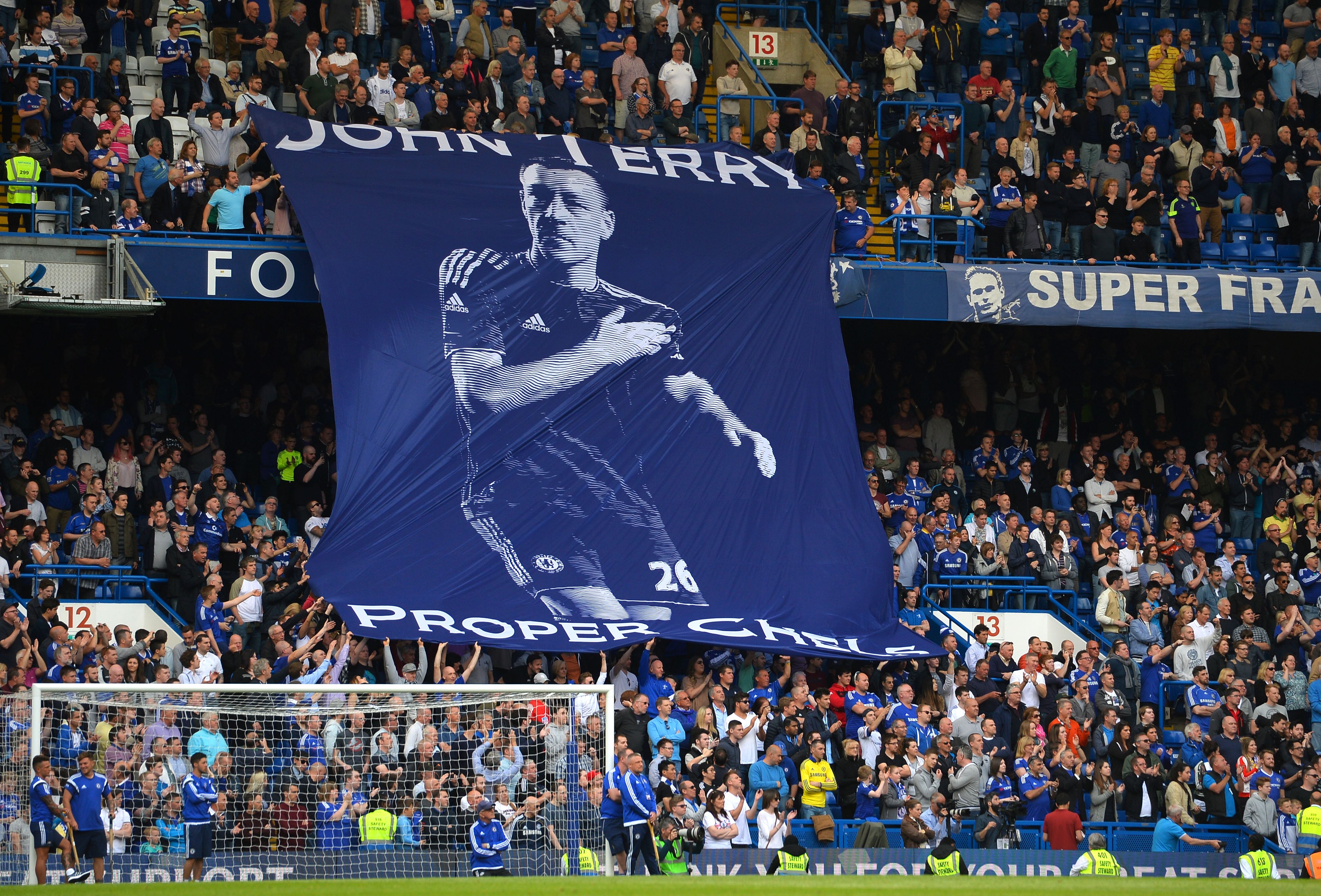 TOPSHOT - Chelsea fans unfurl a banner in support of Chelsea's English defender John Terry after the English Premier League football match between Chelsea and Leicester City at Stamford Bridge in London on May 15, 2016. / AFP / GLYN KIRK / RESTRICTED TO EDITORIAL USE. No use with unauthorized audio, video, data, fixture lists, club/league logos or 'live' services. Online in-match use limited to 75 images, no video emulation. No use in betting, games or single club/league/player publications.  /         (Photo credit should read GLYN KIRK/AFP/Getty Images)