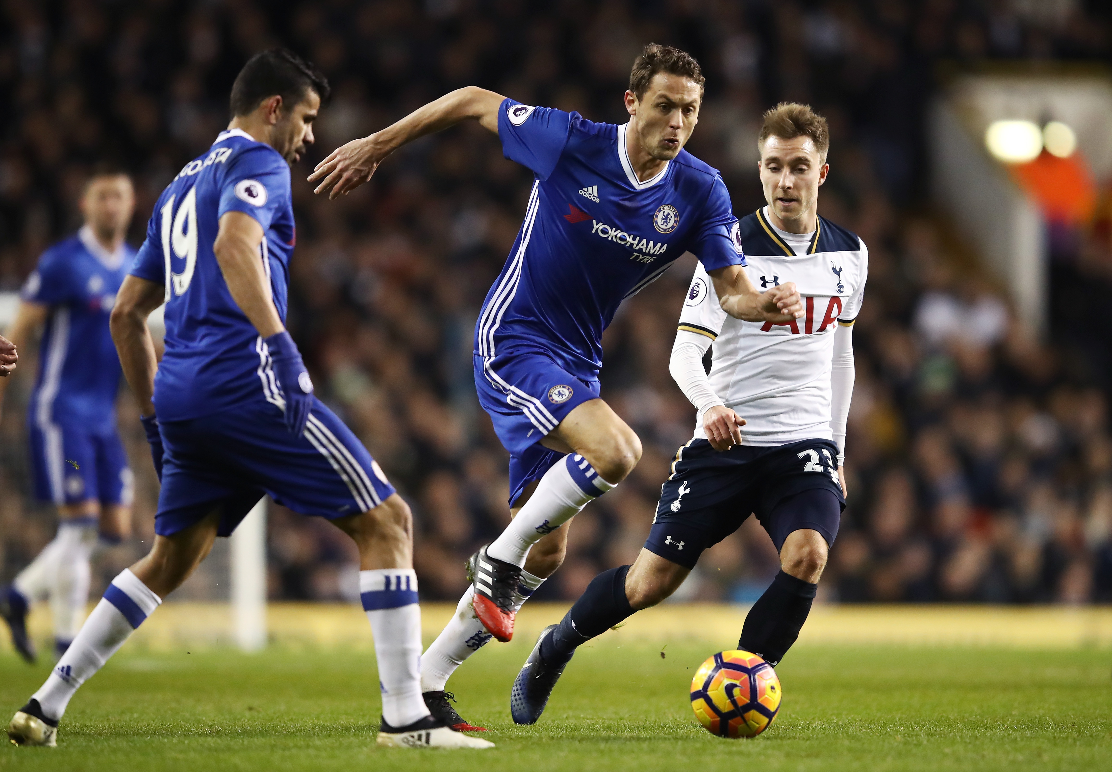 LONDON, ENGLAND - JANUARY 04: Nemanja Matic of Chelsea (C) attempts to take the ball past Christian Eriksen of Tottenham Hotspur (R) during the Premier League match between Tottenham Hotspur and Chelsea at White Hart Lane on January 4, 2017 in London, England.  (Photo by Julian Finney/Getty Images)