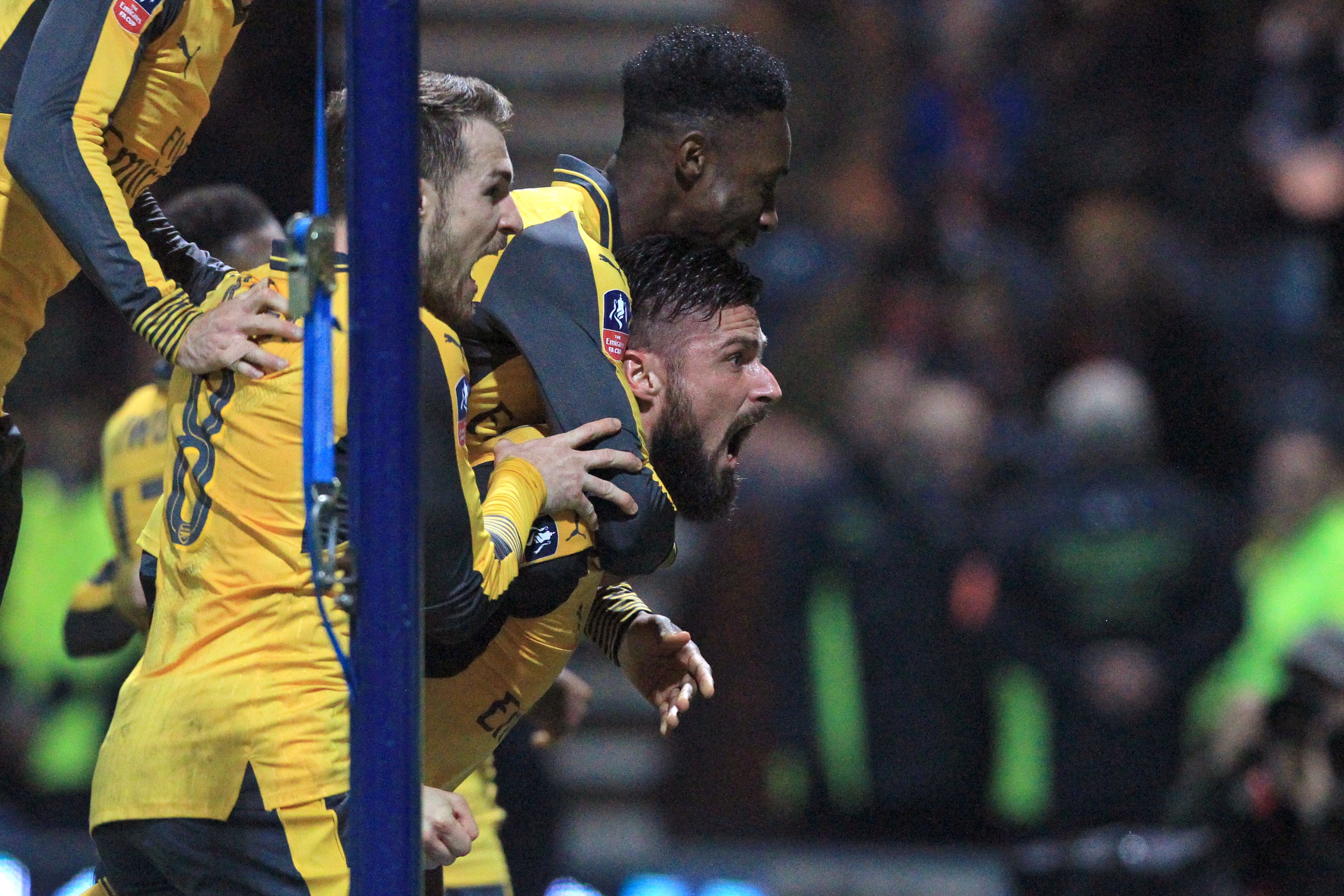 Arsenal's French striker Olivier Giroud (R) celebrates with Arsenal's English striker Danny Welbeck and Arsenal's Welsh midfielder Aaron Ramsey (L) after scoring their second goal during the English FA Cup third round football match between Preston North End and Arsenal at Deepdale in north west England on January 7, 2017.
Arsenal won the game 2-1. / AFP / Lindsey PARNABY / RESTRICTED TO EDITORIAL USE. No use with unauthorized audio, video, data, fixture lists, club/league logos or 'live' services. Online in-match use limited to 75 images, no video emulation. No use in betting, games or single club/league/player publications.  /         (Photo credit should read LINDSEY PARNABY/AFP/Getty Images)