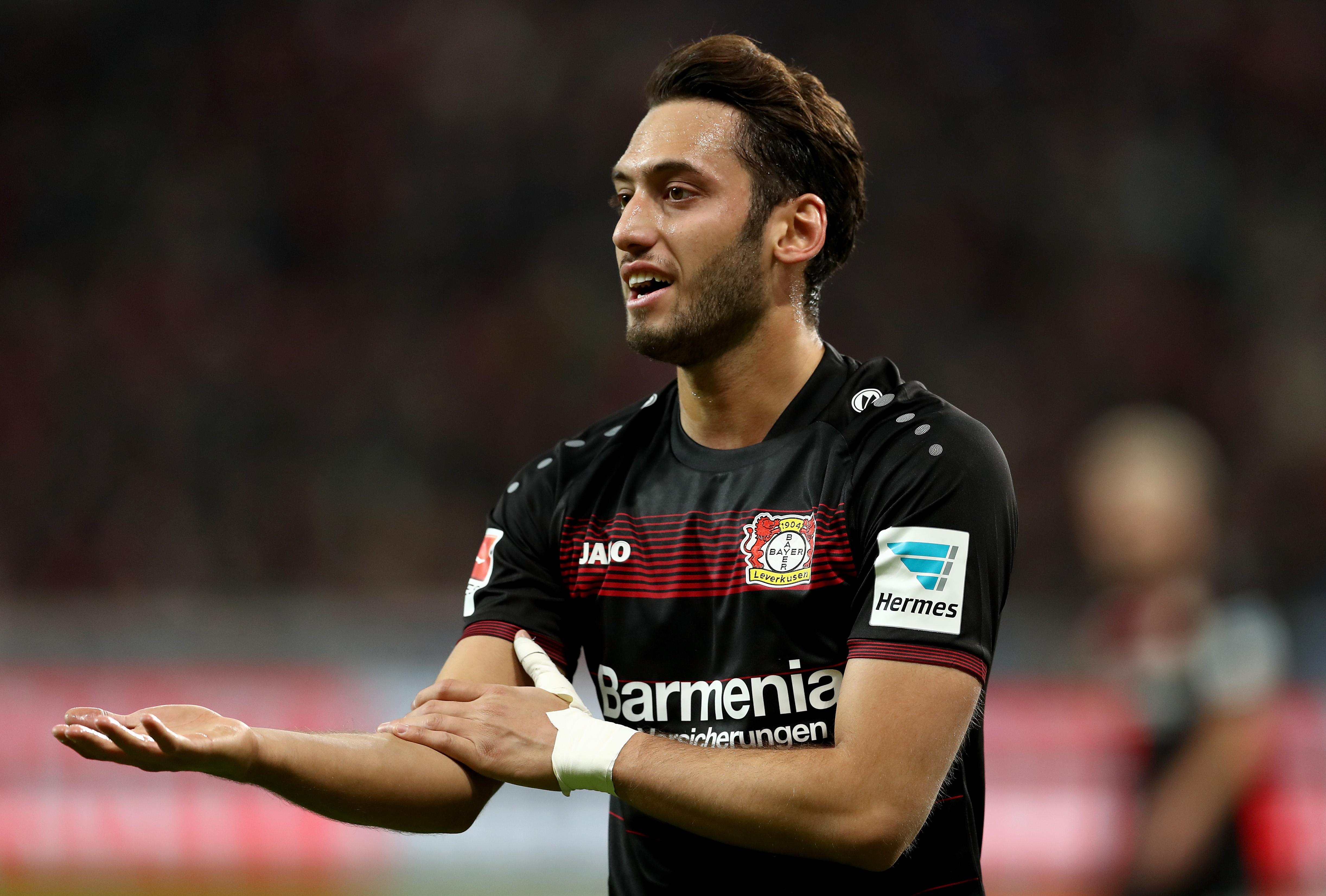 LEVERKUSEN, GERMANY - JANUARY 28:  Hakan Calhanoglu of Bayer Leverkusen gestures during the Bundesliga match between Bayer 04 Leverkusen and Borussia Moenchengladbach at BayArena on January 28, 2017 in Leverkusen, Germany.  (Photo by Lars Baron/Bongarts/Getty Images)