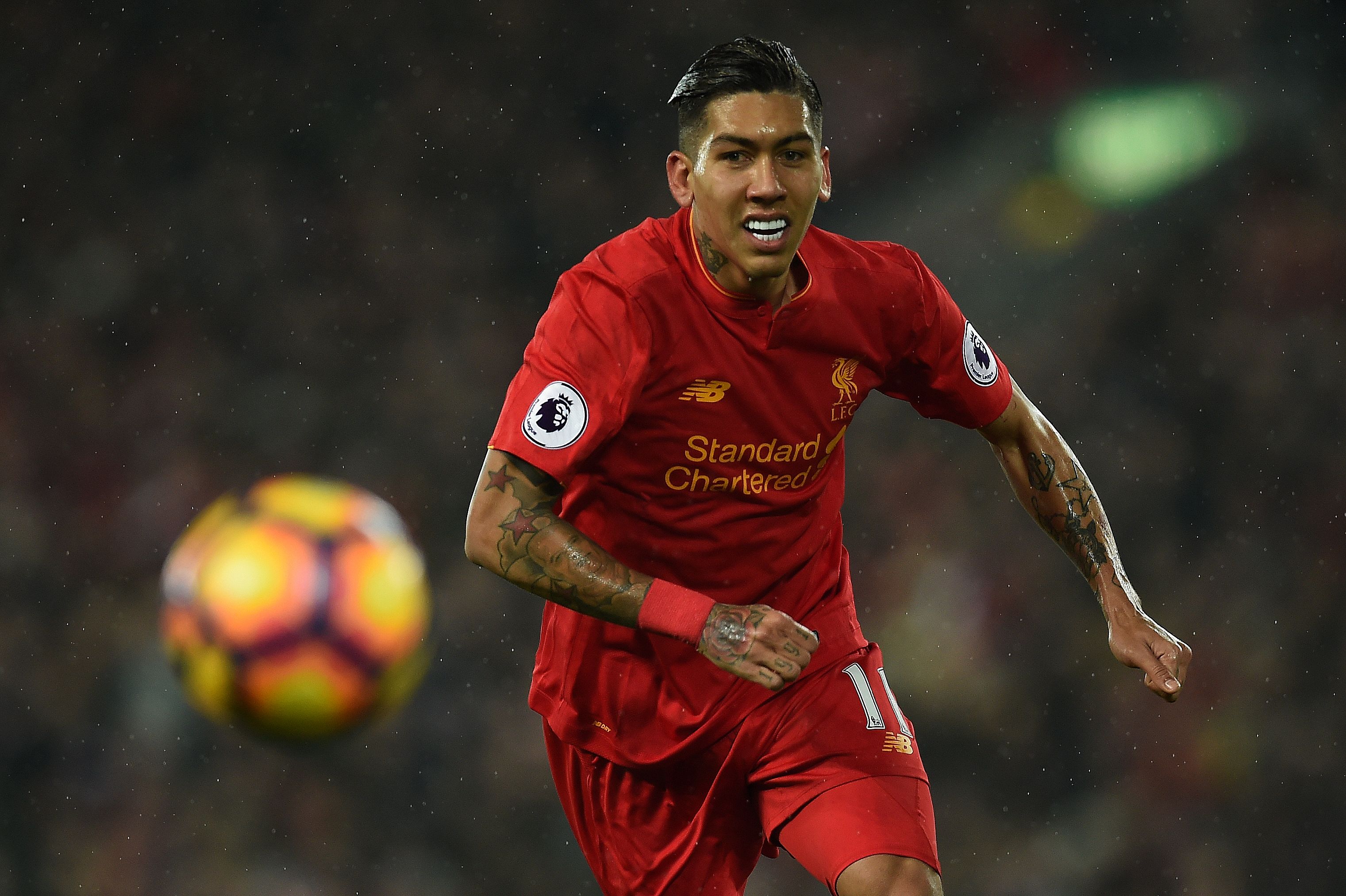 Liverpool's Brazilian midfielder Roberto Firmino chanses the ball during the English Premier League football match between Liverpool and Chelsea at Anfield in Liverpool, north west England on January 31, 2017. / AFP / PAUL ELLIS / RESTRICTED TO EDITORIAL USE. No use with unauthorized audio, video, data, fixture lists, club/league logos or 'live' services. Online in-match use limited to 75 images, no video emulation. No use in betting, games or single club/league/player publications.  /         (Photo credit should read PAUL ELLIS/AFP/Getty Images)