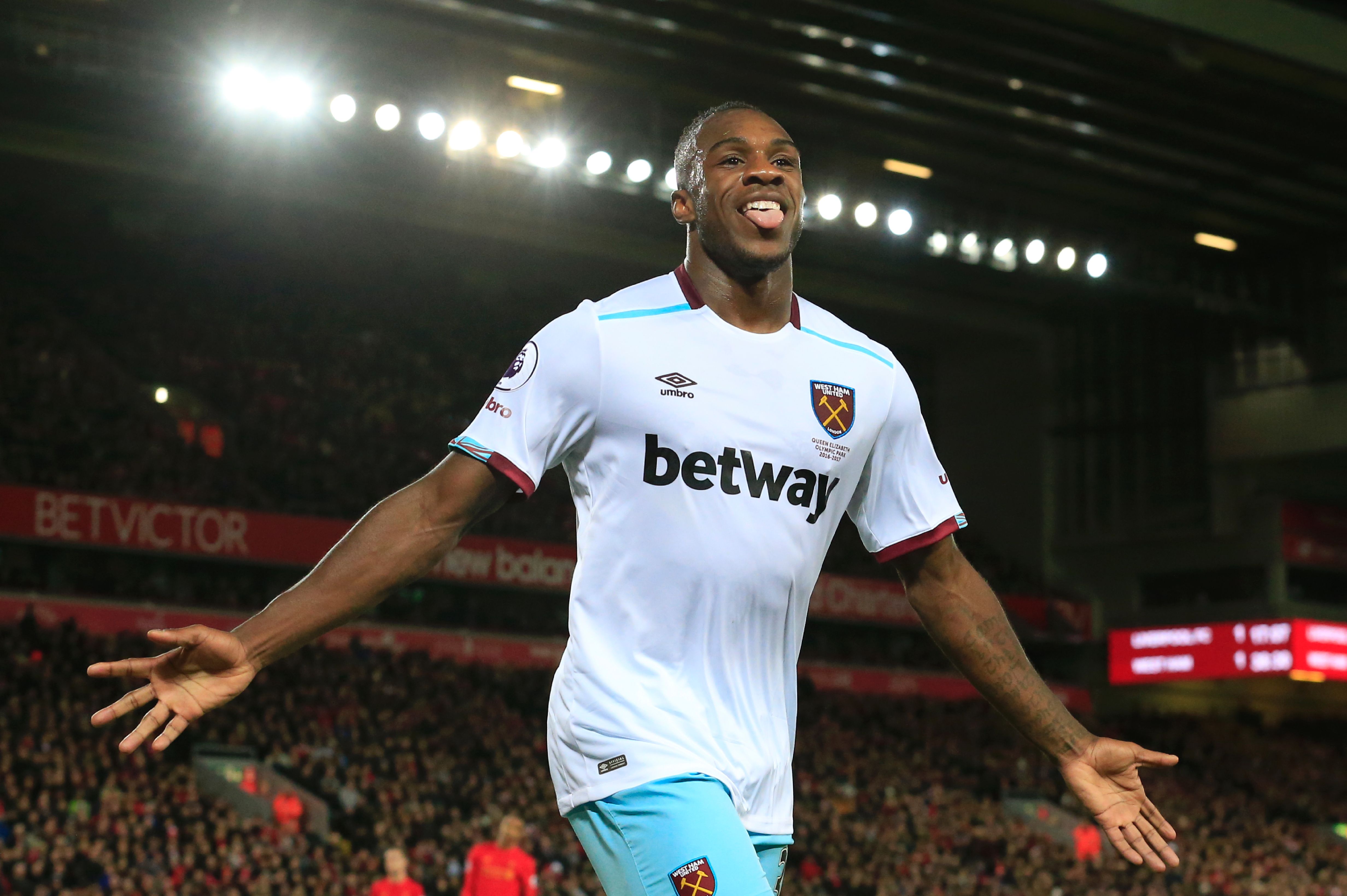 West Ham United's English midfielder Michail Antonio celebrates scoring their second goal during the English Premier League football match between Liverpool and West Ham United at Anfield in Liverpool, north west England on December 11, 2016. / AFP / Lindsey PARNABY / RESTRICTED TO EDITORIAL USE. No use with unauthorized audio, video, data, fixture lists, club/league logos or 'live' services. Online in-match use limited to 75 images, no video emulation. No use in betting, games or single club/league/player publications.  /         (Photo credit should read LINDSEY PARNABY/AFP/Getty Images)