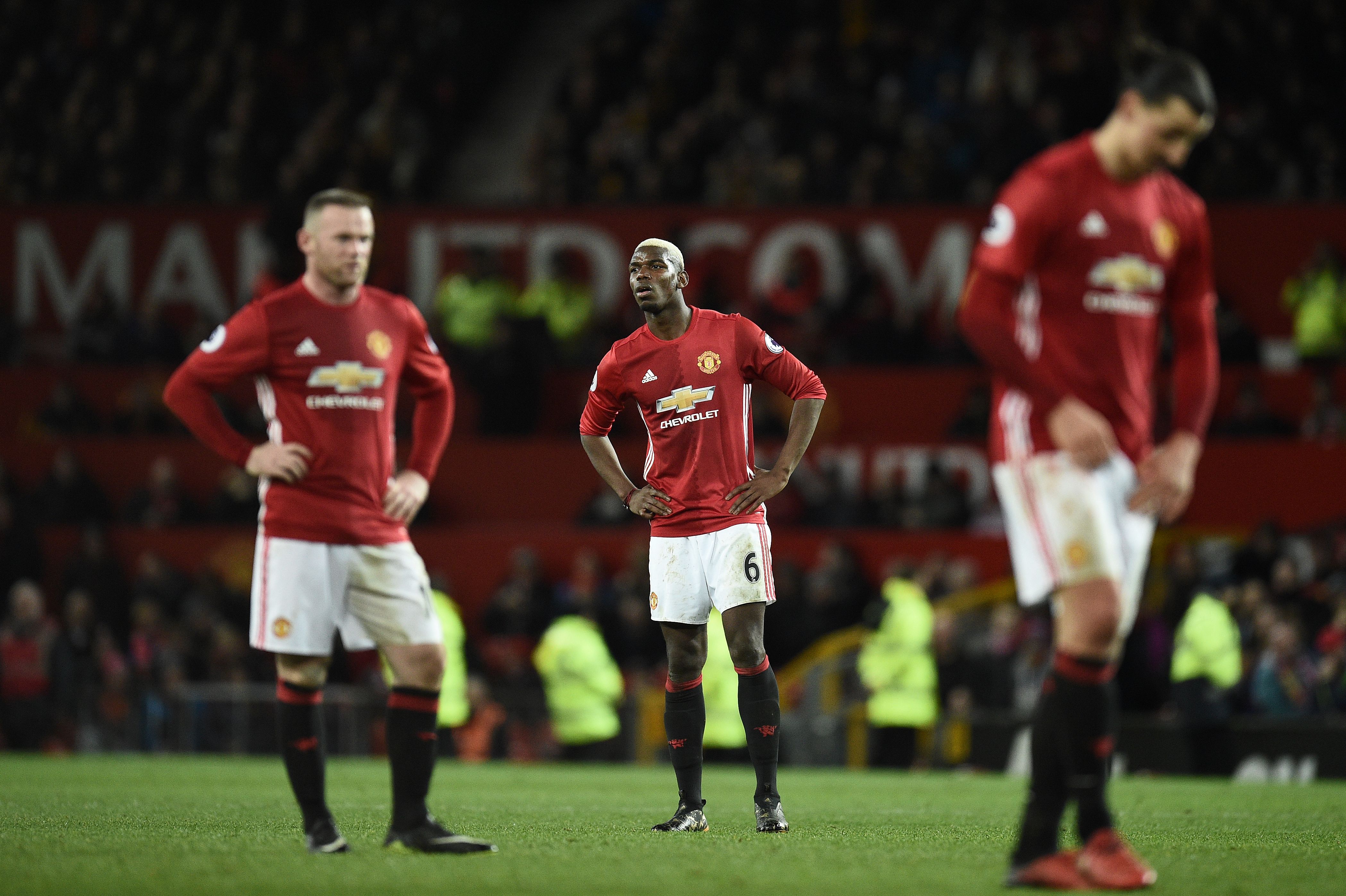 Manchester United's English striker Wayne Rooney (L) Manchester United's French midfielder Paul Pogba and Manchester United's Swedish striker Zlatan Ibrahimovic react following the English Premier League football match between Manchester United and Hull City at Old Trafford in Manchester, north west England, on February 1, 2017.
The match ended in a draw at 0-0. / AFP / Oli SCARFF / RESTRICTED TO EDITORIAL USE. No use with unauthorized audio, video, data, fixture lists, club/league logos or 'live' services. Online in-match use limited to 75 images, no video emulation. No use in betting, games or single club/league/player publications.  /         (Photo credit should read OLI SCARFF/AFP/Getty Images)