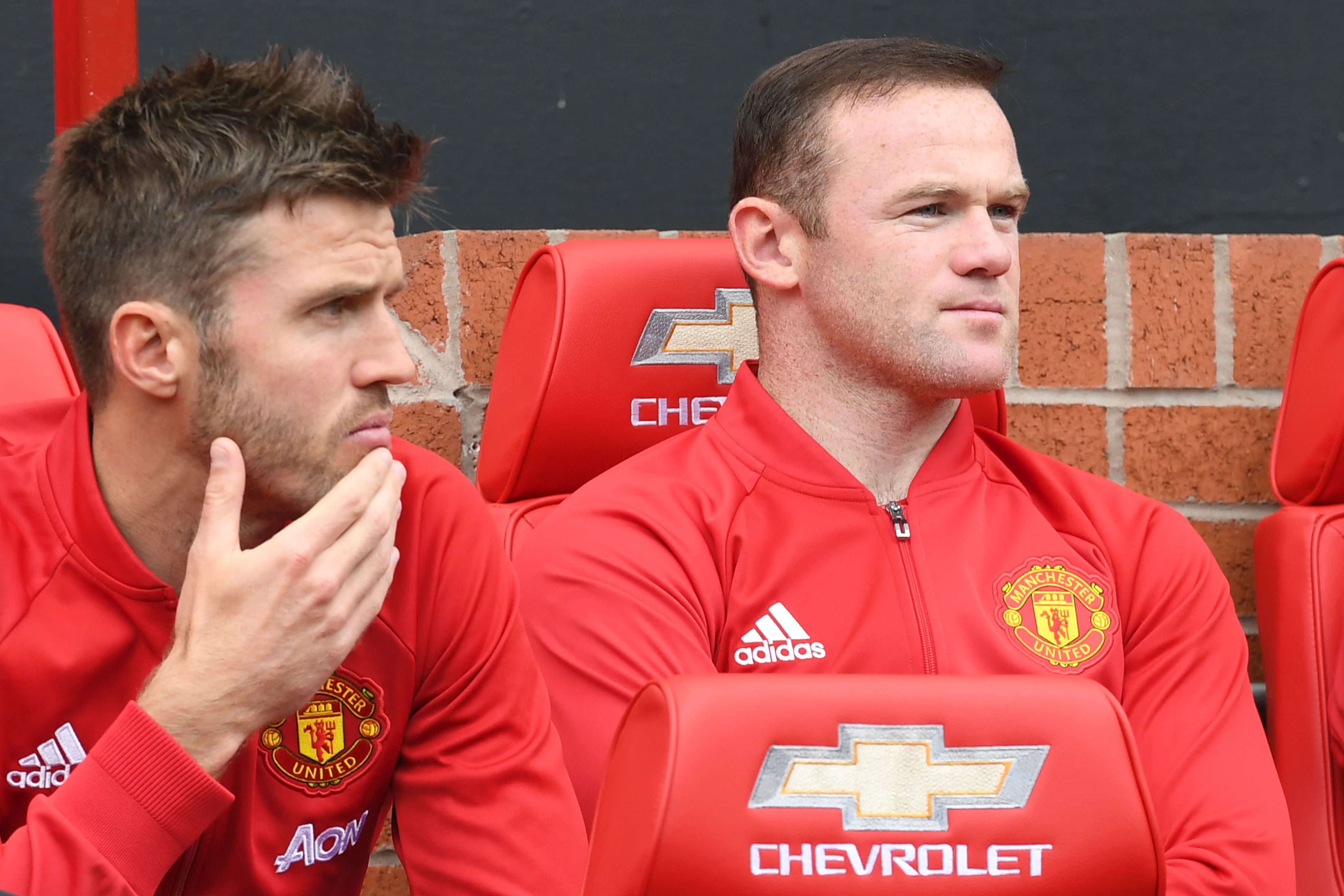 Manchester United's English striker Wayne Rooney (R) sits on the substitutes bench with Manchester United's English midfielder Michael Carrick (L) during the English Premier League football match between Manchester United and Leicester City at Old Trafford in Manchester, north west England, on September 24, 2016. / AFP / ANTHONY DEVLIN / RESTRICTED TO EDITORIAL USE. No use with unauthorized audio, video, data, fixture lists, club/league logos or 'live' services. Online in-match use limited to 75 images, no video emulation. No use in betting, games or single club/league/player publications.  /         (Photo credit should read ANTHONY DEVLIN/AFP/Getty Images)