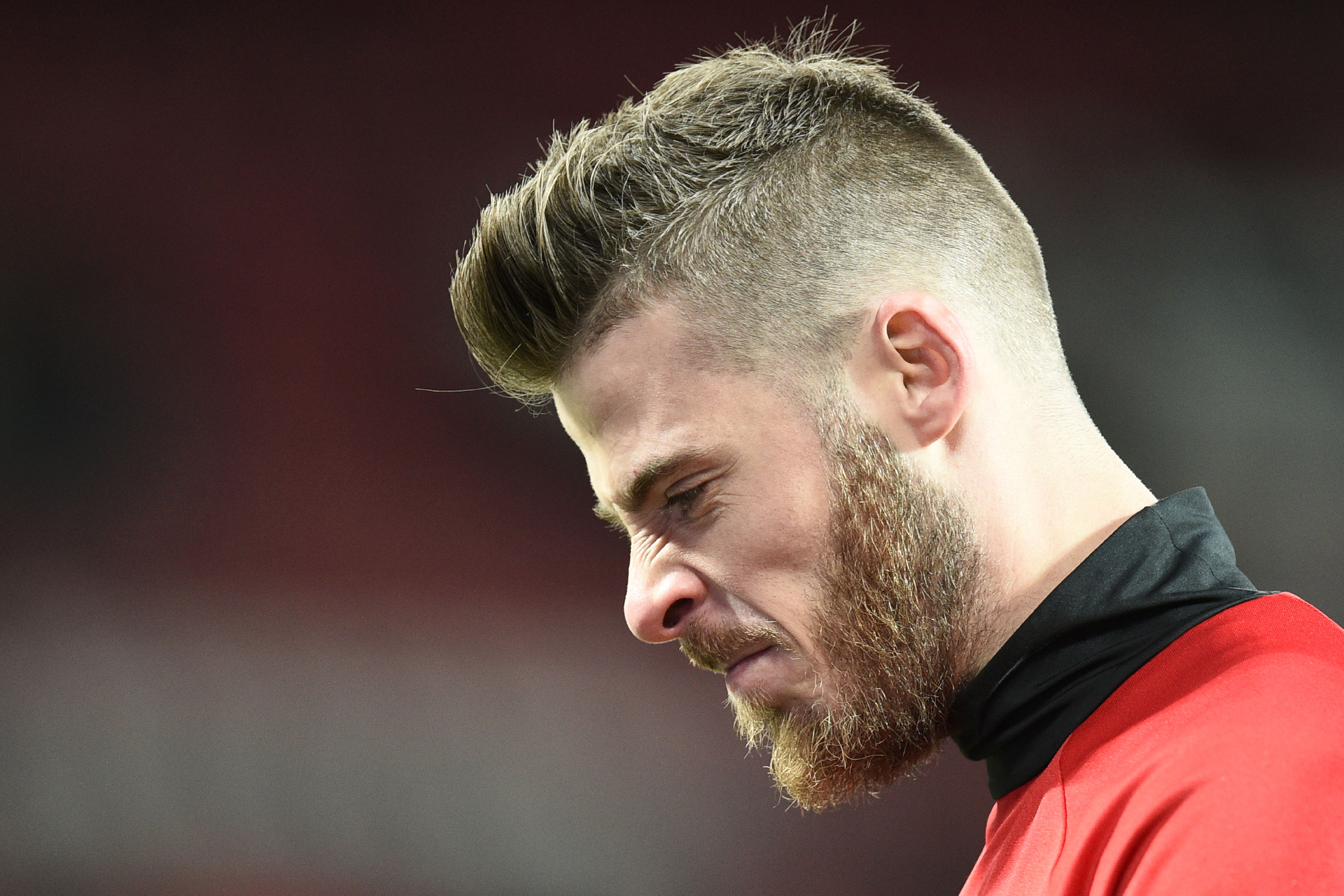 Manchester United's Spanish goalkeeper David de Gea warms up for the English Premier League football match between Manchester United and West Ham United at Old Trafford in Manchester, north west England, on November 27, 2016. / AFP / Oli SCARFF / RESTRICTED TO EDITORIAL USE. No use with unauthorized audio, video, data, fixture lists, club/league logos or 'live' services. Online in-match use limited to 75 images, no video emulation. No use in betting, games or single club/league/player publications.  /         (Photo credit should read OLI SCARFF/AFP/Getty Images)