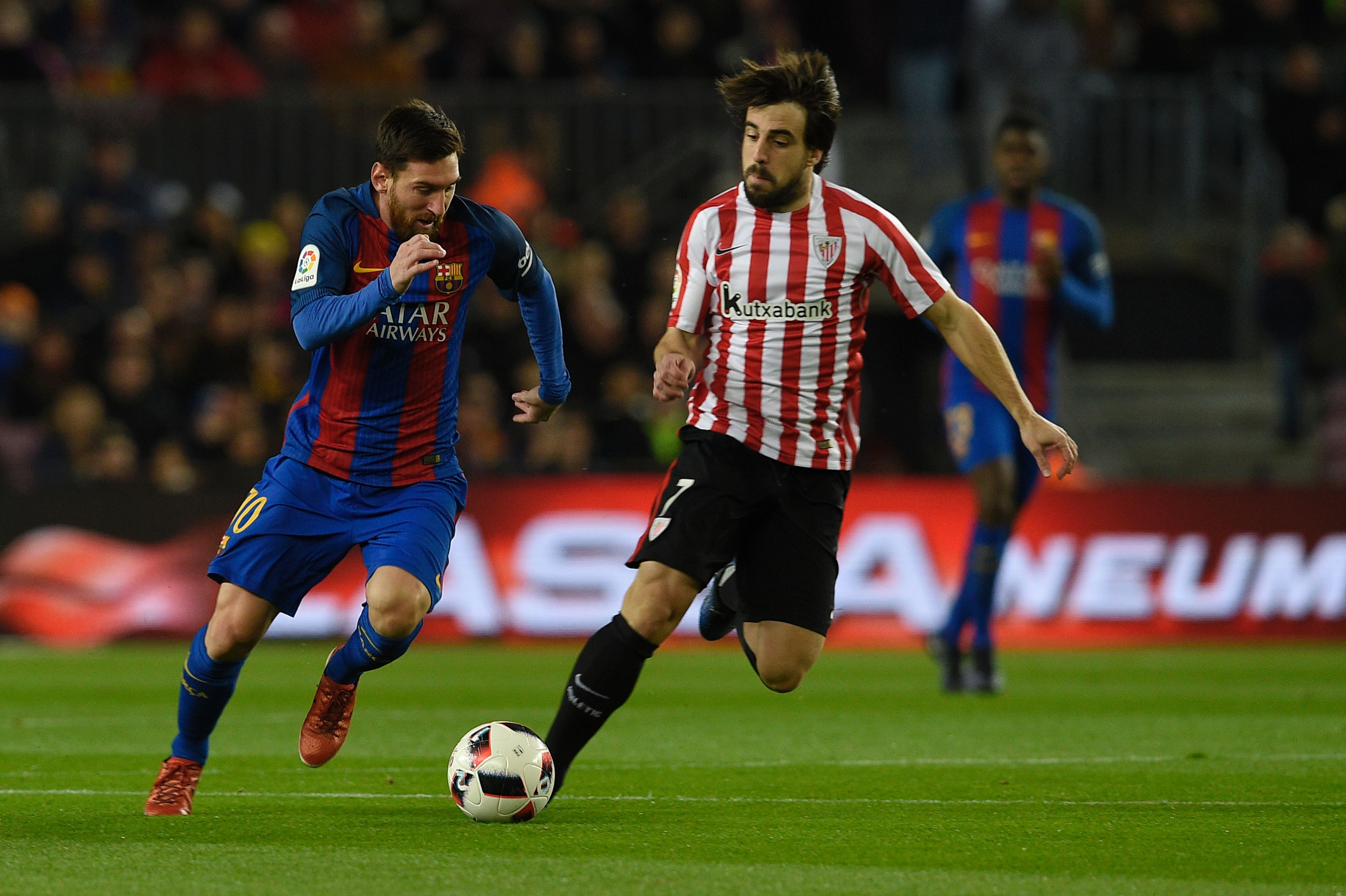 Barcelona's Argentinian forward Lionel Messi (L) vies with Athletic Bilbao's midfielder Benat Etxebarria Urkiaga (R) during the Spanish Copa del Rey (King's Cup) round of 16 second leg football match FC Barcelona vs Athletic Club de Bilbao at the Camp Nou stadium in Barcelona on January 11, 2017. / AFP / LLUIS GENE        (Photo credit should read LLUIS GENE/AFP/Getty Images)