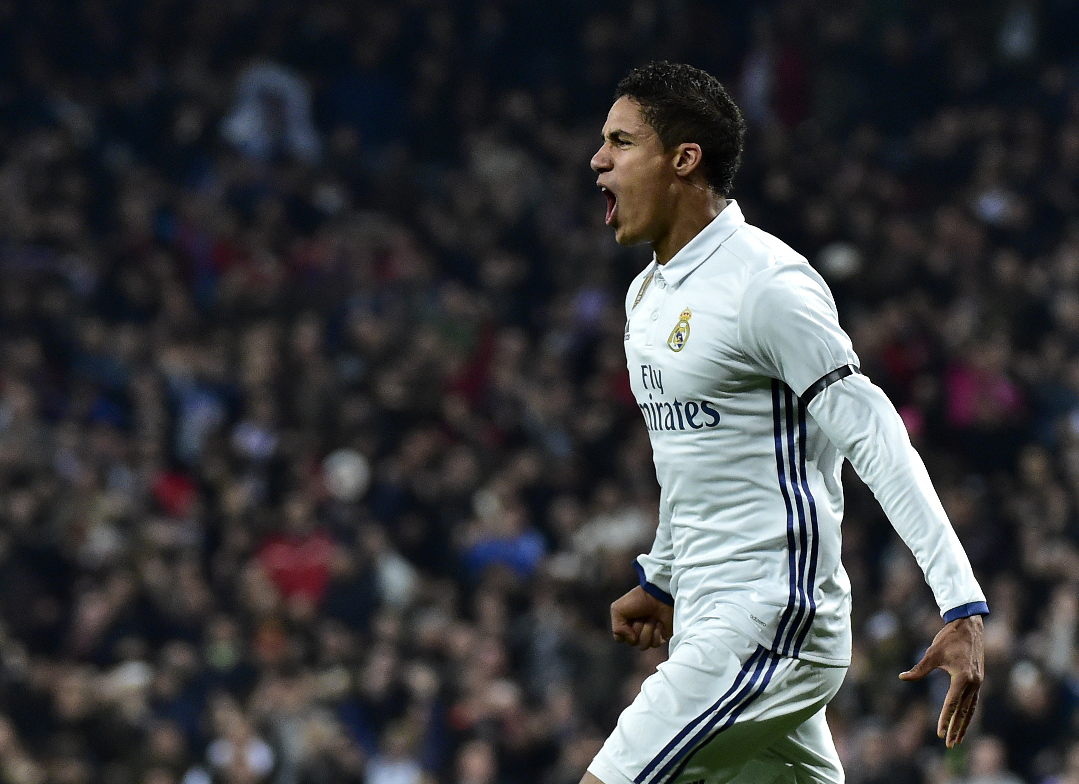Real Madrid's French defender Raphael Varane celebrates after scoring during the Spanish Copa del Rey (King's Cup) round of 16 first leg football match Real Madrid CF vs Sevilla FC at the Santiago Bernabeu stadium in Madrid on January 4, 2017. / AFP / GERARD JULIEN        (Photo credit should read GERARD JULIEN/AFP/Getty Images)