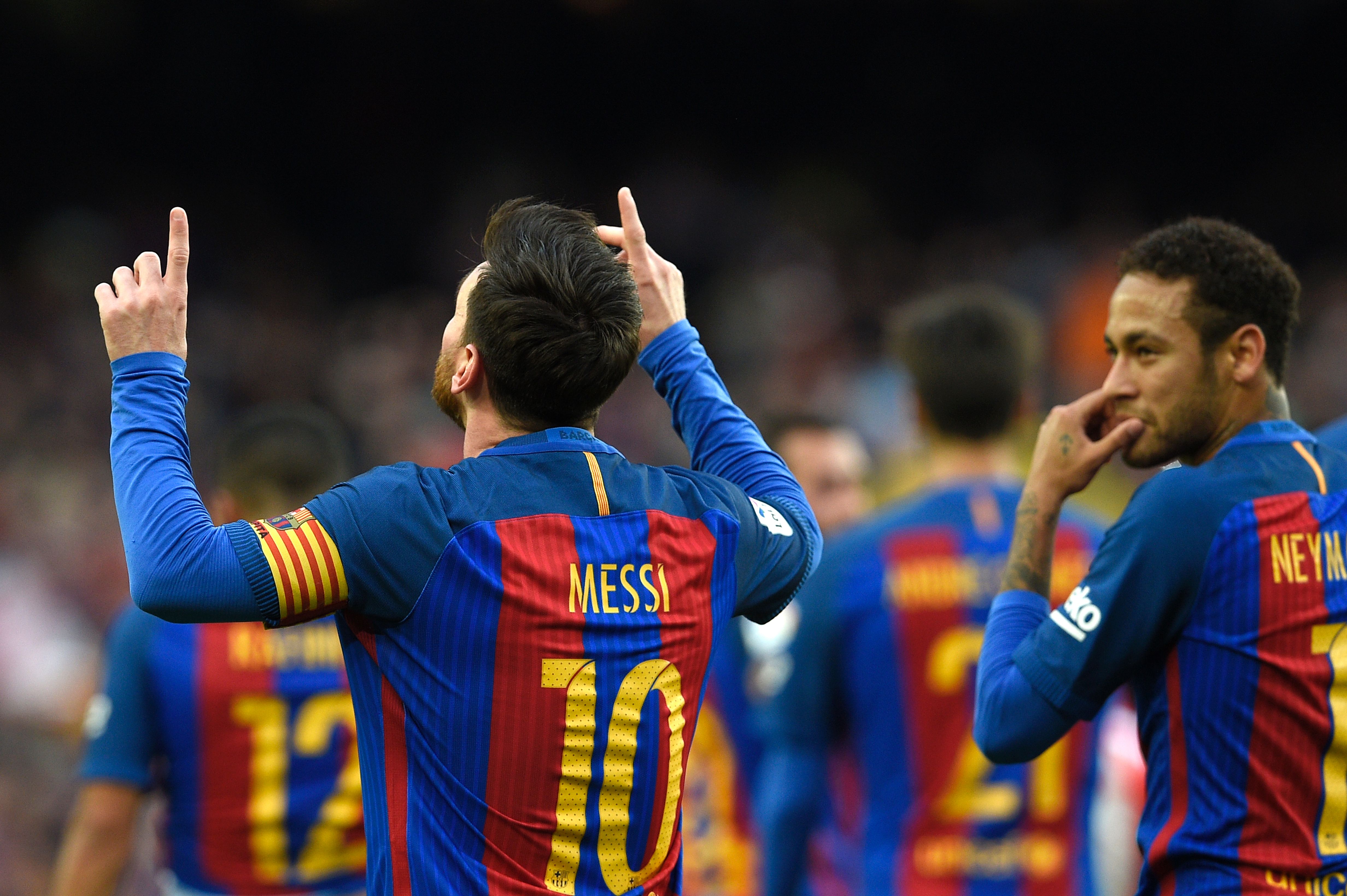 Barcelona's Argentinian forward Lionel Messi (L) celebrates beside Barcelona's Brazilian forward Neymar (R) after scoring a goal during the Spanish league football match FC Barcelona vs Athletic Club Bilbao at the Camp Nou stadium in Barcelona on February 4, 2017. / AFP / LLUIS GENE        (Photo credit should read LLUIS GENE/AFP/Getty Images)