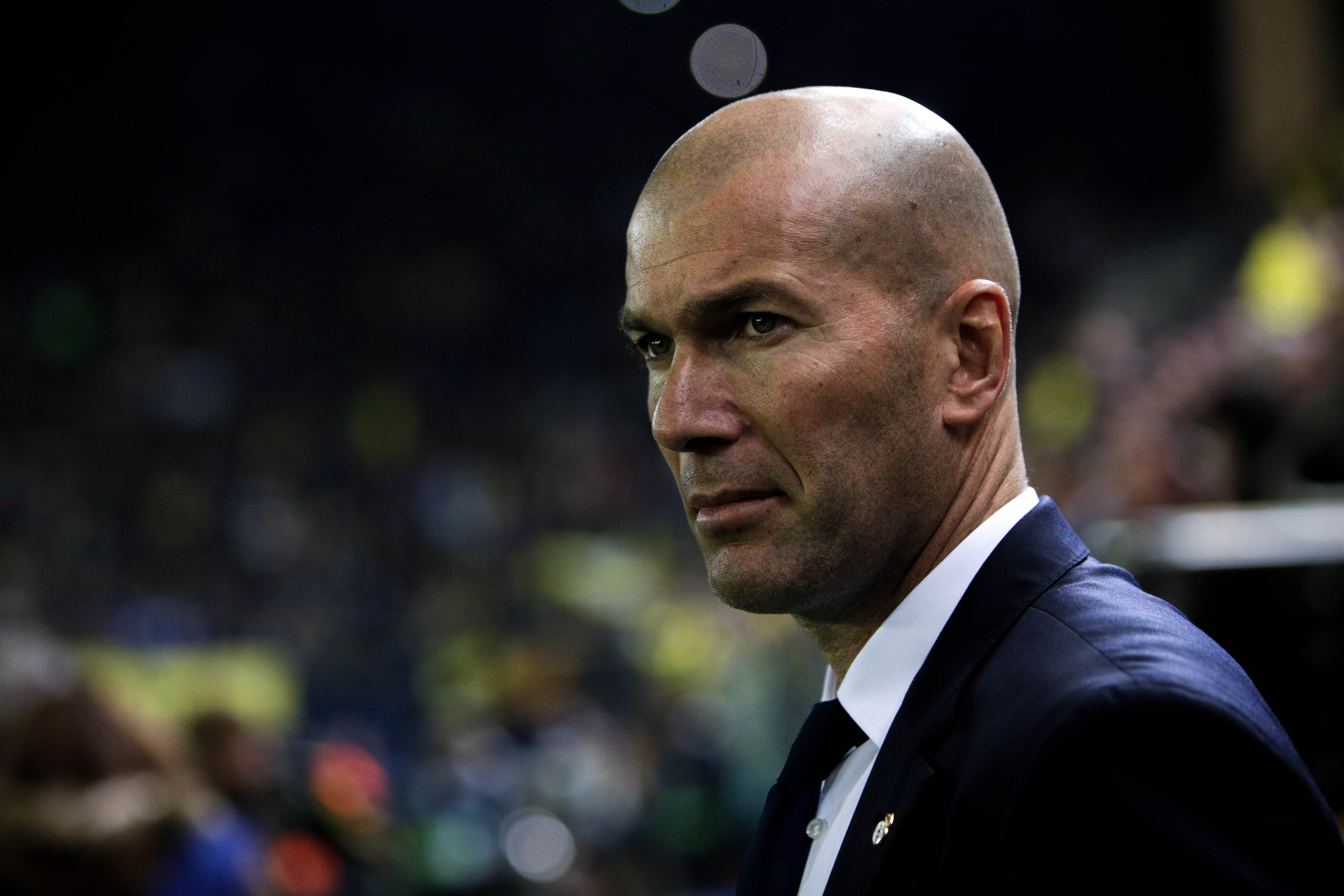 Real Madrid's coach, Zinedine Zidane, looks on during the Spanish League football match Villarreal CF vs Real Madrid at El Madrigal stadium in Vila-real on February 26, 2017.  / AFP / BIEL ALINO        (Photo credit should read BIEL ALINO/AFP/Getty Images)