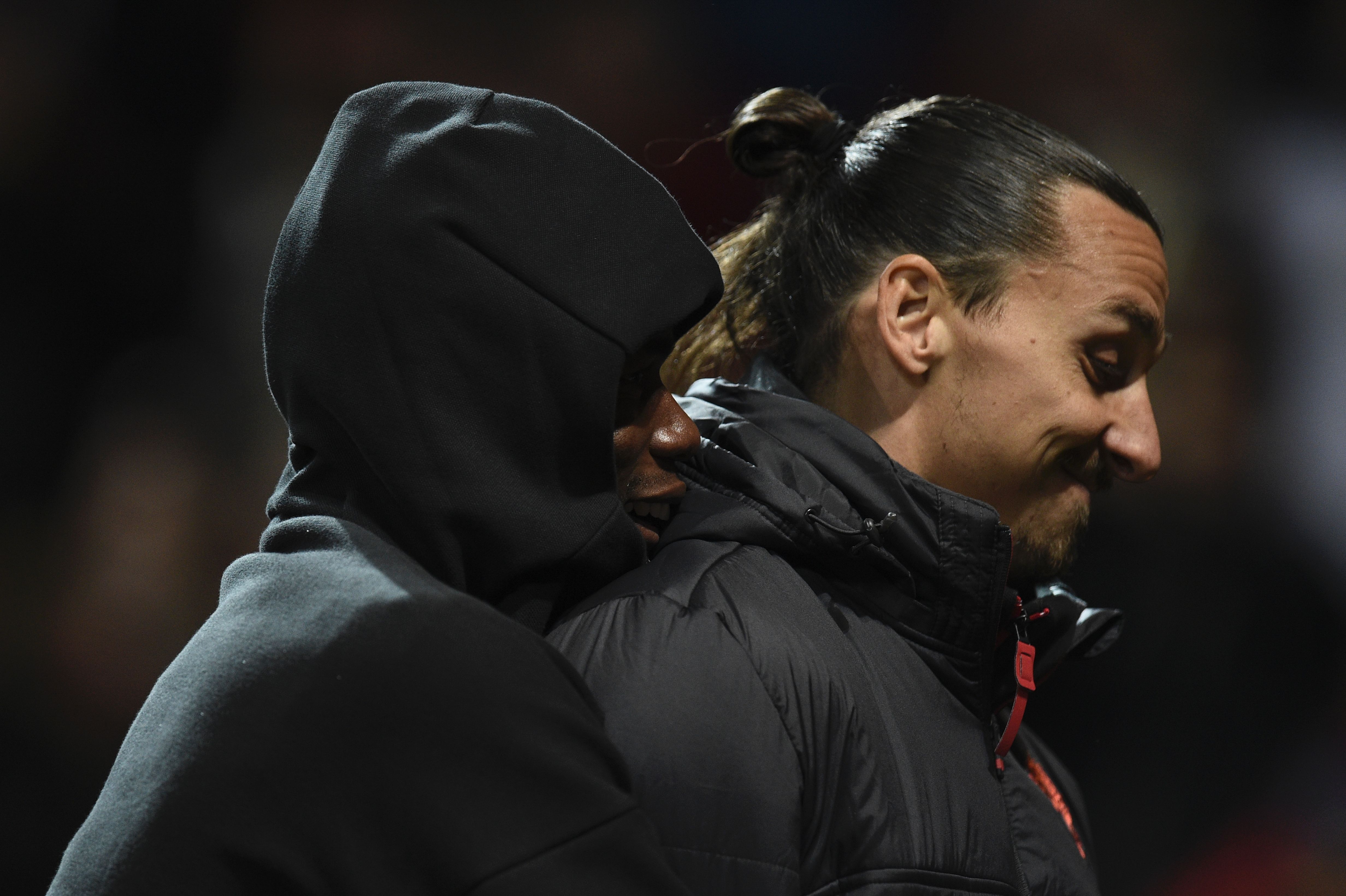 Manchester United's French midfielder Paul Pogba (L) hugs Manchester United's Swedish striker Zlatan Ibrahimovic (R) after the final whistle in the UEFA Europa League group A football match between Manchester United and Fenerbahce at Old Trafford in Manchester, north west England, on October 20, 2016. / AFP / OLI SCARFF        (Photo credit should read OLI SCARFF/AFP/Getty Images)